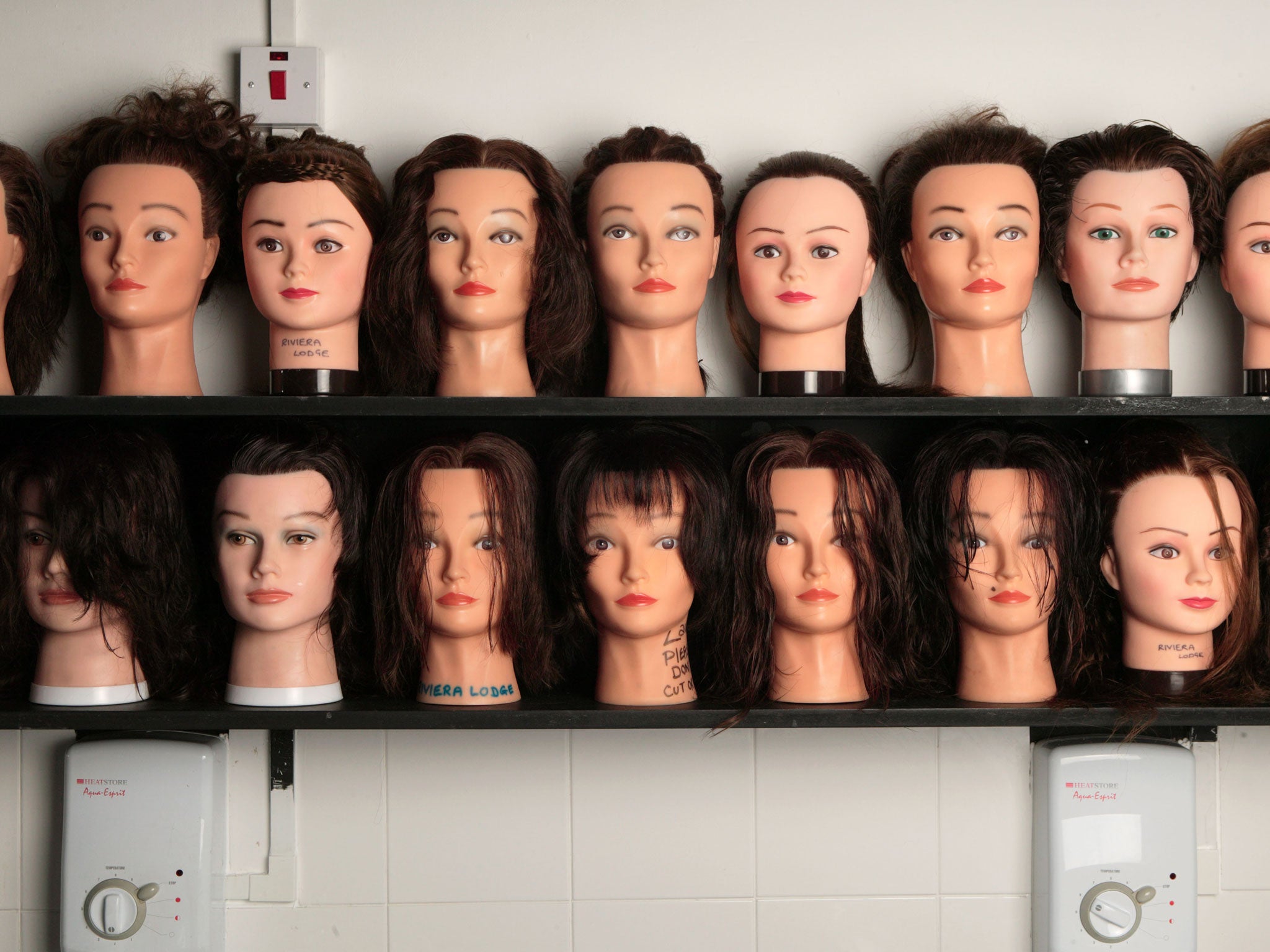 Hairdressers model heads on a shelf
