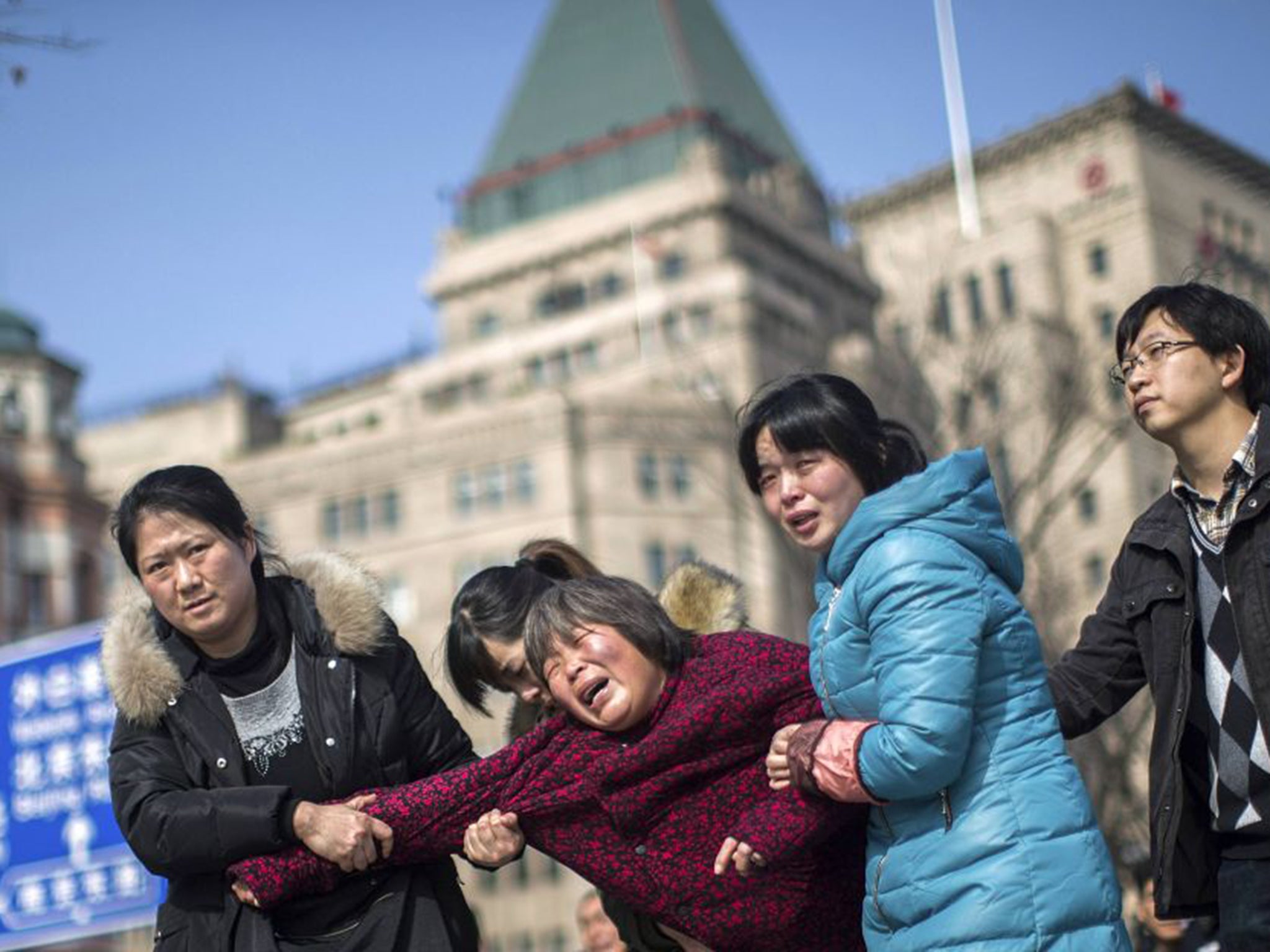 Grieving relatives after the Shanghai stampede. Local newspapers were instructed not to use photos showing people mourning for the dead (Reuters)