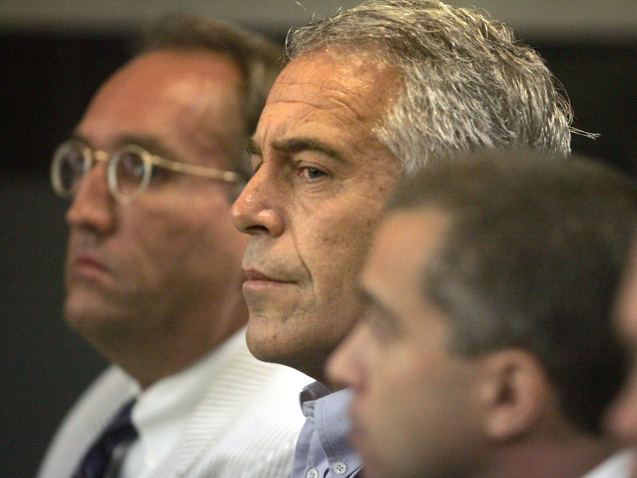 Billionaire financier Jeffrey Epstein (centre) whose lawyers are reportedly 'petrified' about where the journal will go