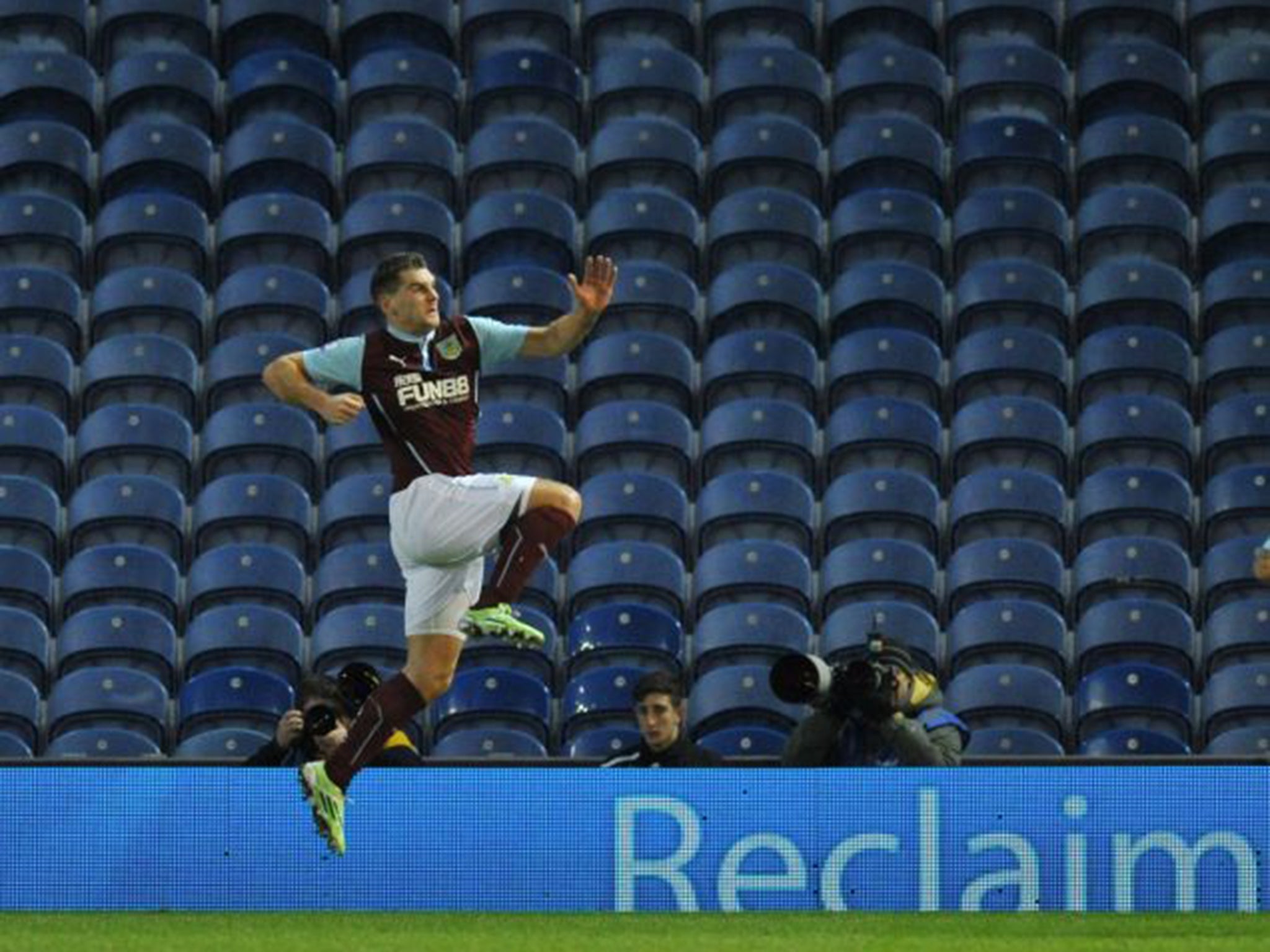 Burnley’s Sam Vokes celebrates his goal in front of rows of empty seats at Turf Moor on Monday night (Getty)