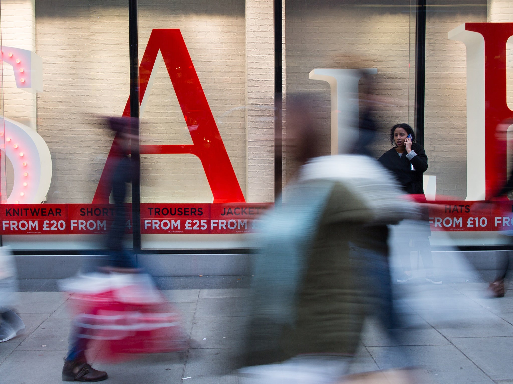 People walk along Oxford Street in central London