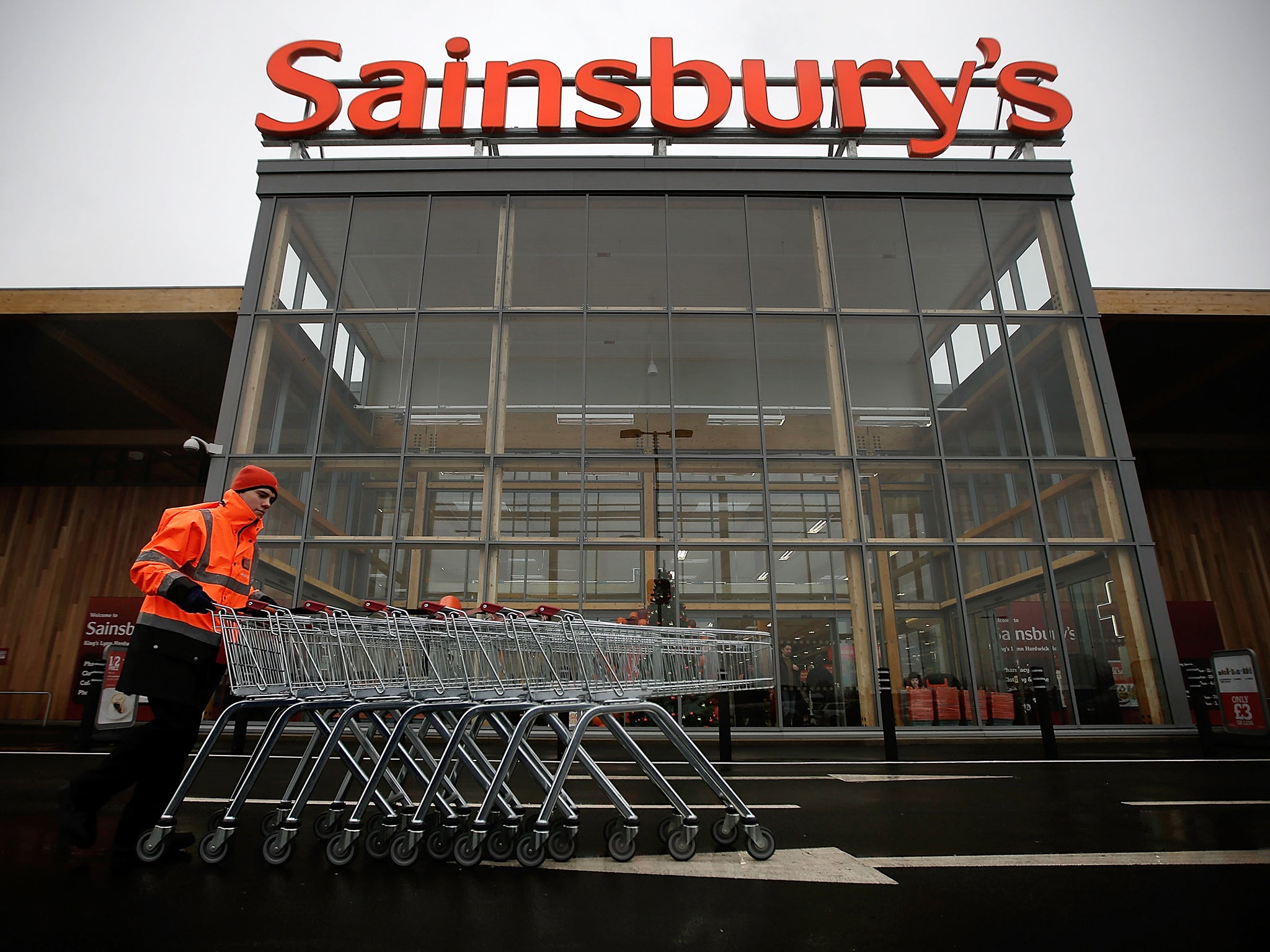 A colleague moves trolleys in the car park of Sainsbury's new Kings Lynn supermarket.