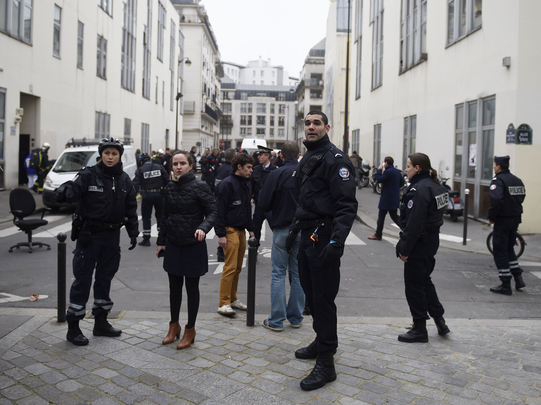 Police forces gather in street outside the offices in Paris