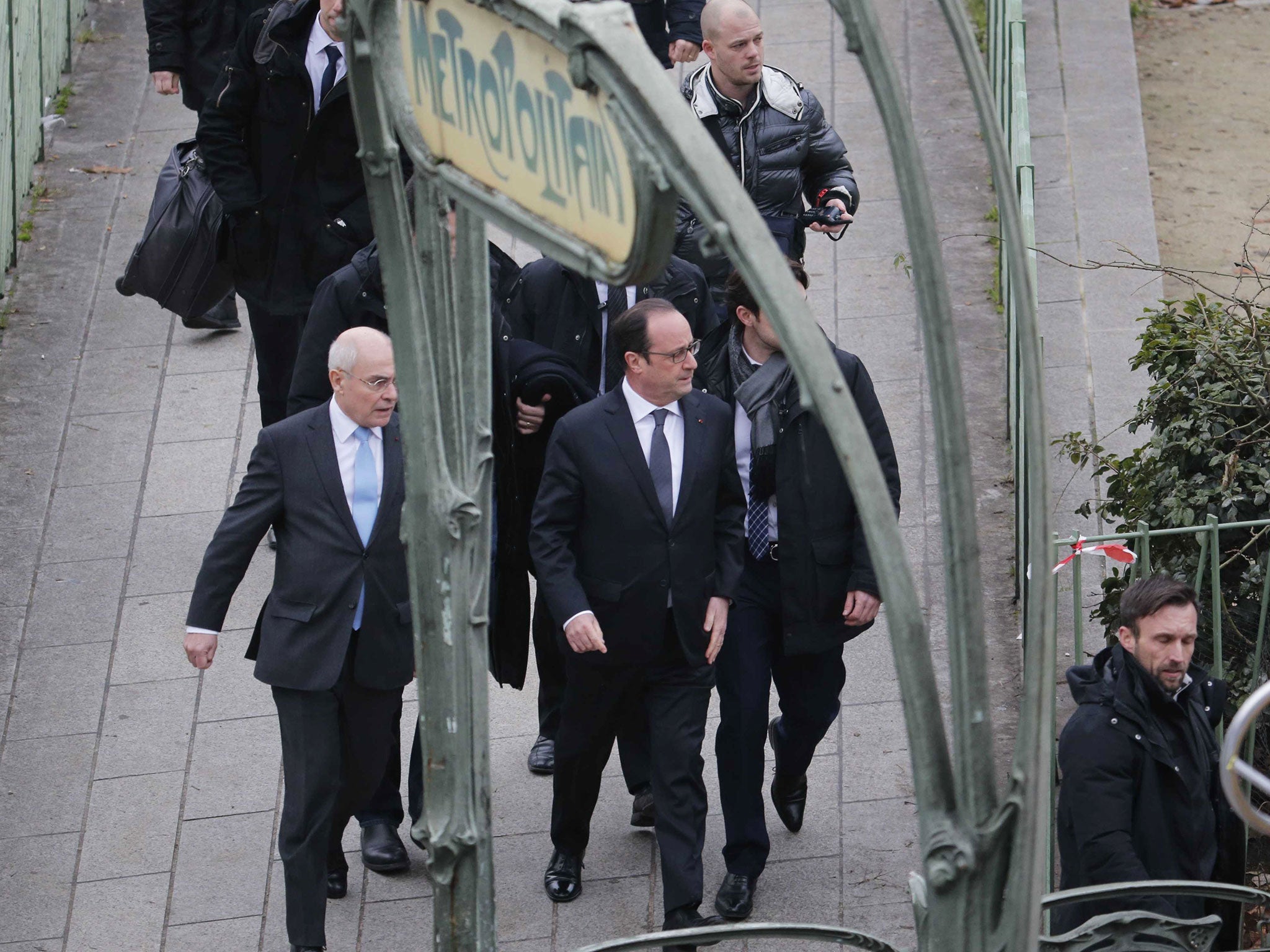 French President Francois Hollande (C) arrives after a shooting at the Paris offices of Charlie Hebdo