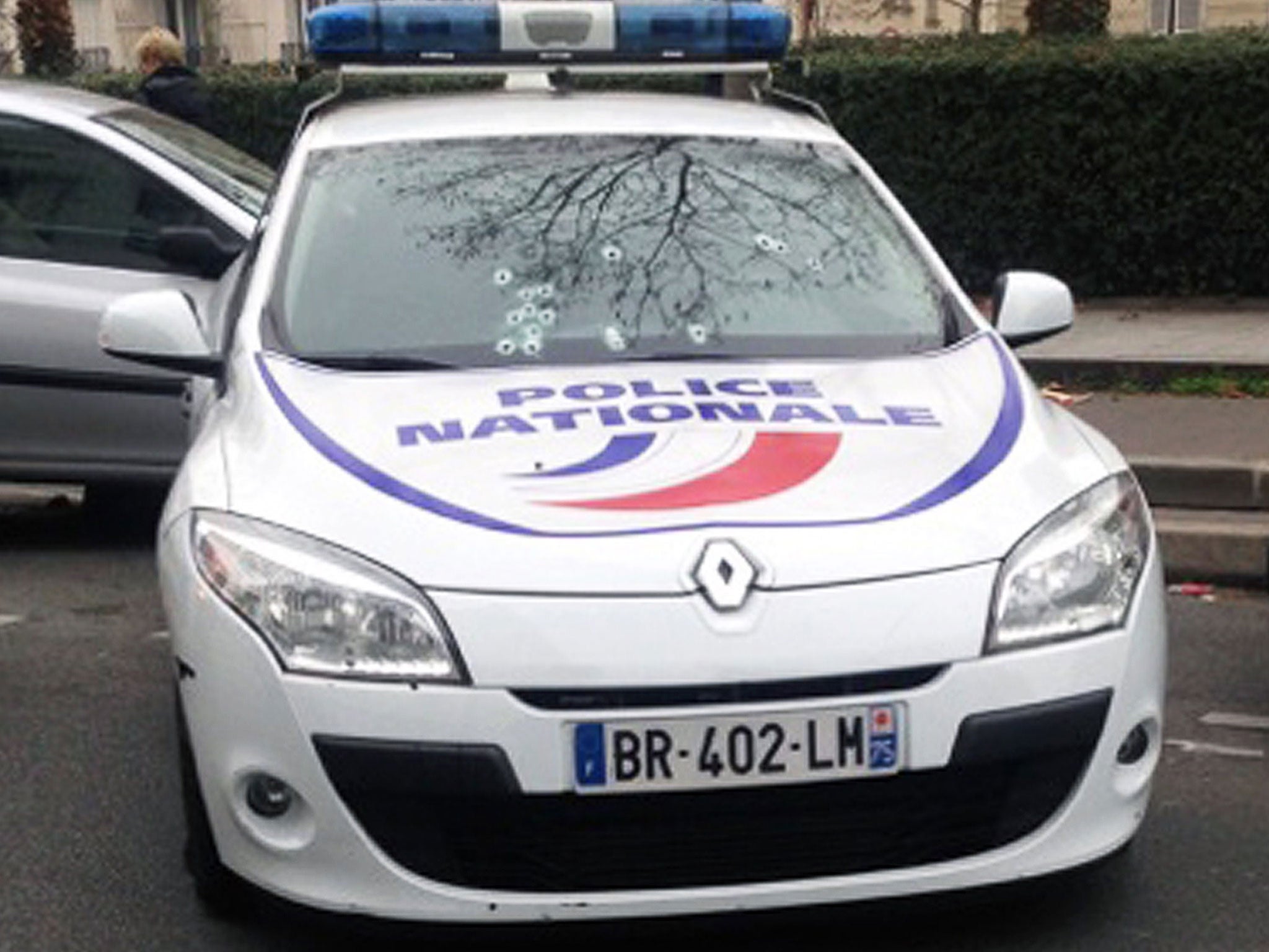 A police car riddled with bullets during an attack on the offices of the newspaper Charlie Hebdo in Paris