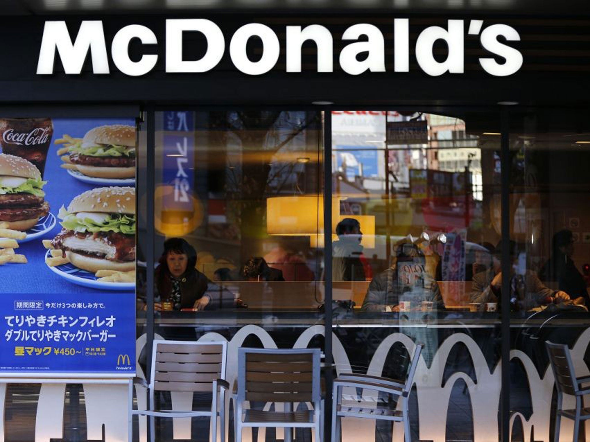 Visitors are seen inside a McDonald's store in Tokyo on 7 January, 2015