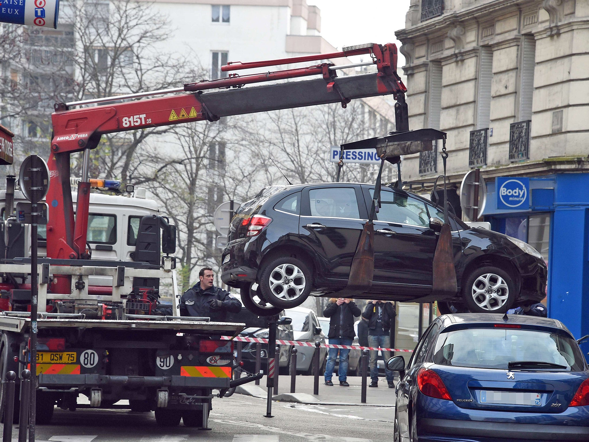 A truck tows the car used by armed gunmen who stormed the Paris offices of satirical newspaper Charlie Hebdo (Getty)