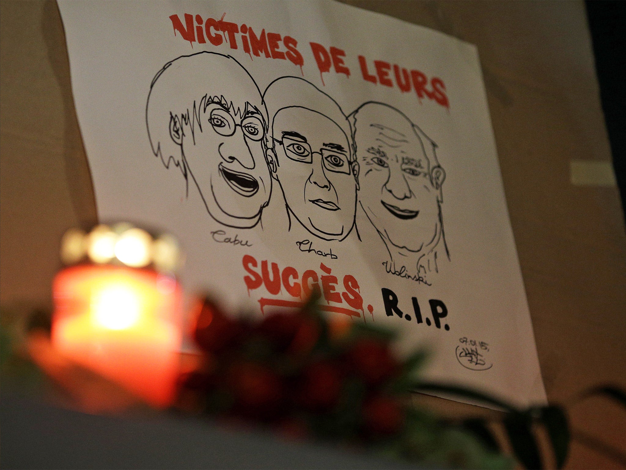 A drawing depicting cartoonist Jean Cabut, left, Charlie Hebdo editor Stephane Charbonnier, center, and cartoonist Georges Wolinski