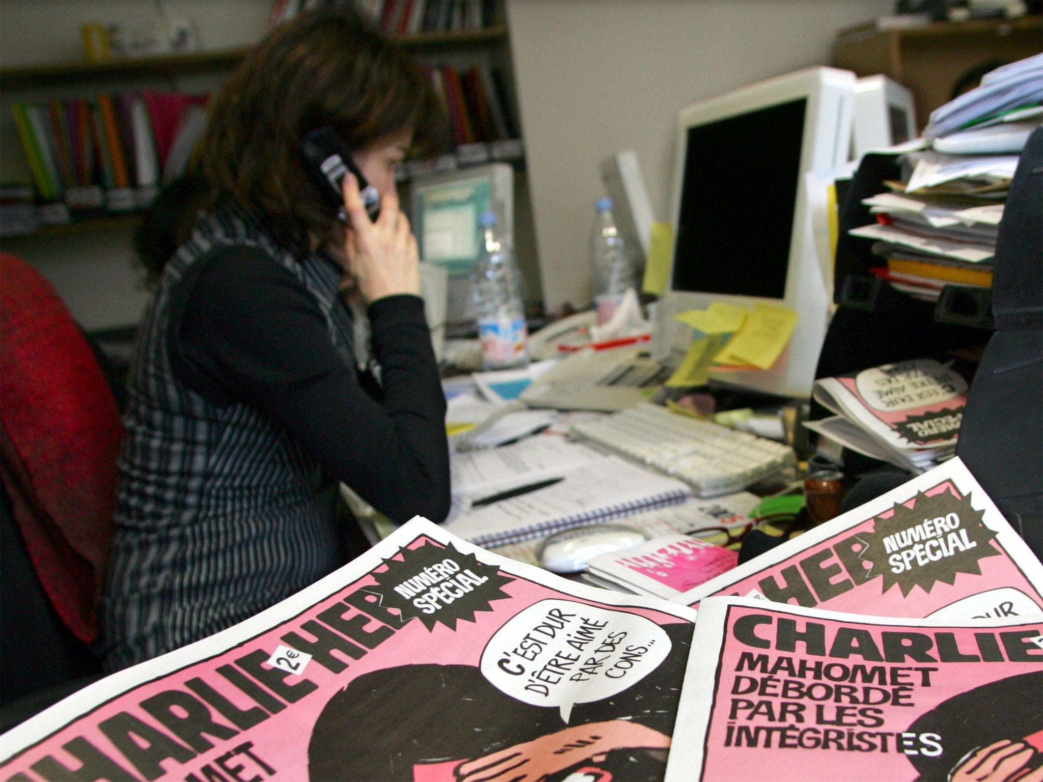 A journalist works in the Paris newsroom of French satirical weekly Charlie Hebdo, in 2006