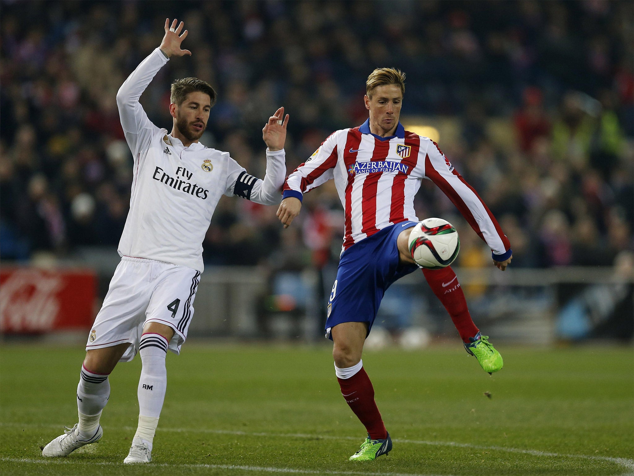 Fernando Torres tries to lift the ball over Real defender Sergio Ramos