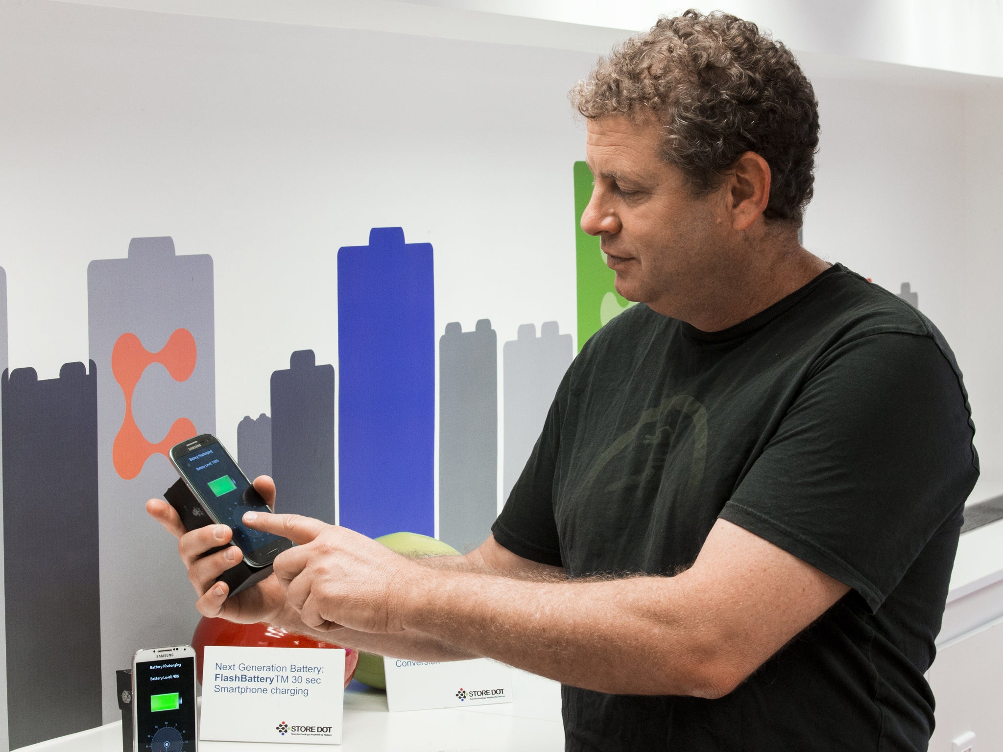 During a demonstration a phone is charged during a demonstration by Israeli startup StoreDot of a bio-organic charger system which they are developing that can recharge a smartphone battery in just 30 seconds at their laboratory in Tel Aviv on April 9, 2014