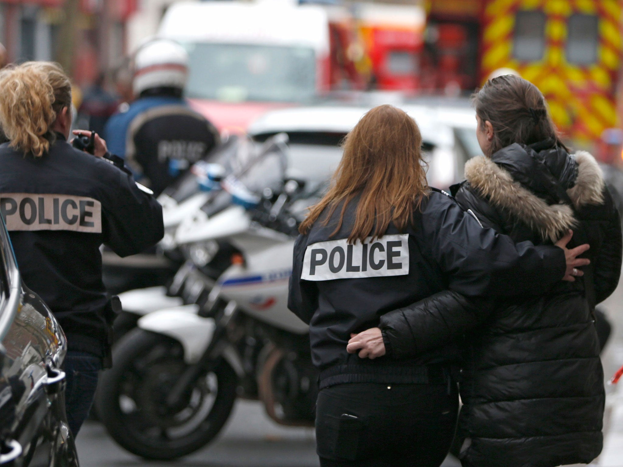 French police assist a woman after a shooting in the street of Montrouge