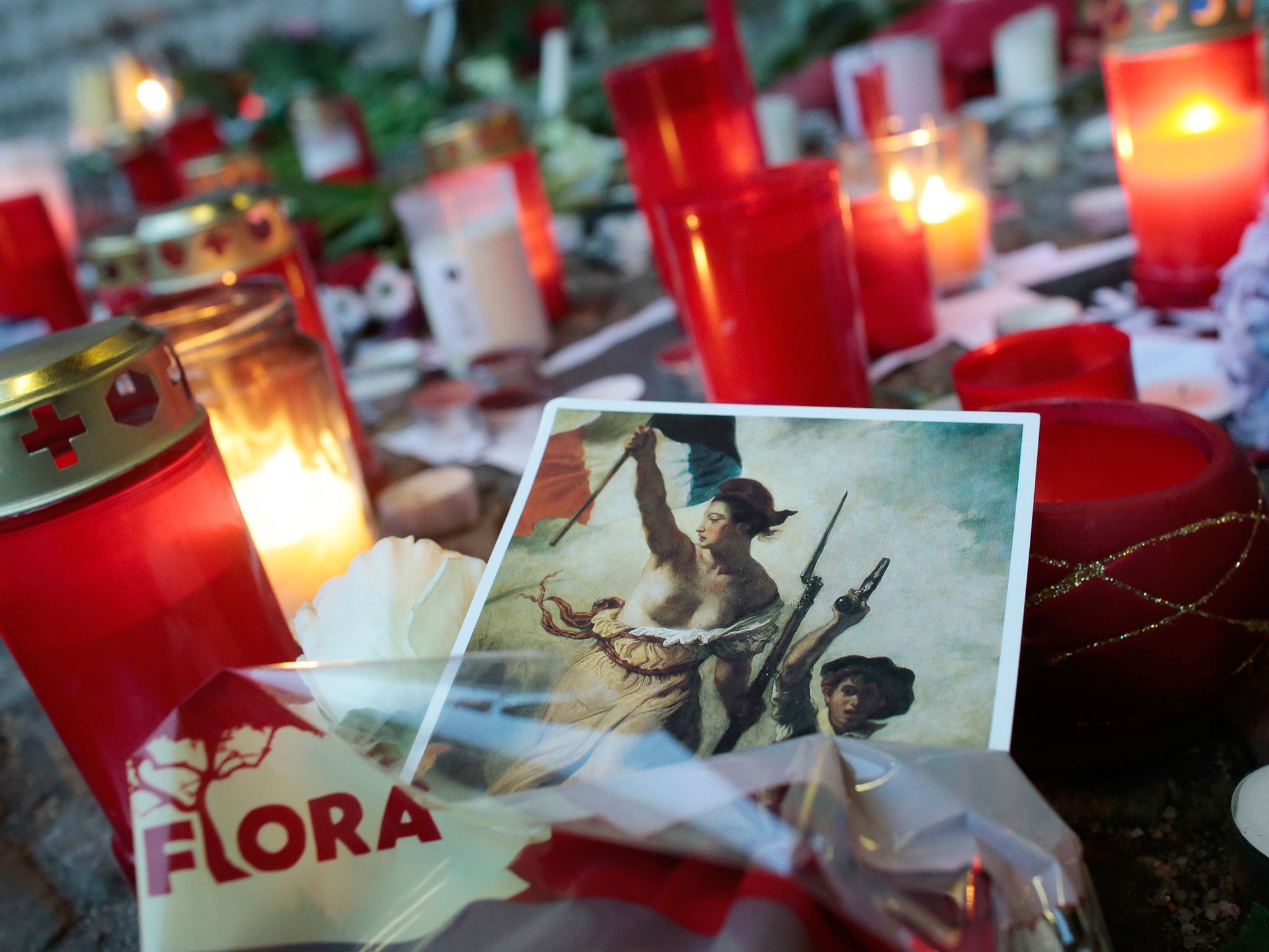 A painting of the 'Marianne', the national symbol of the French Republic is placed between candles to commemorate the victims killed in an attack at the Paris offices of the weekly newspaper Charlie Hebdo, in front of the French Embassy in Berlin