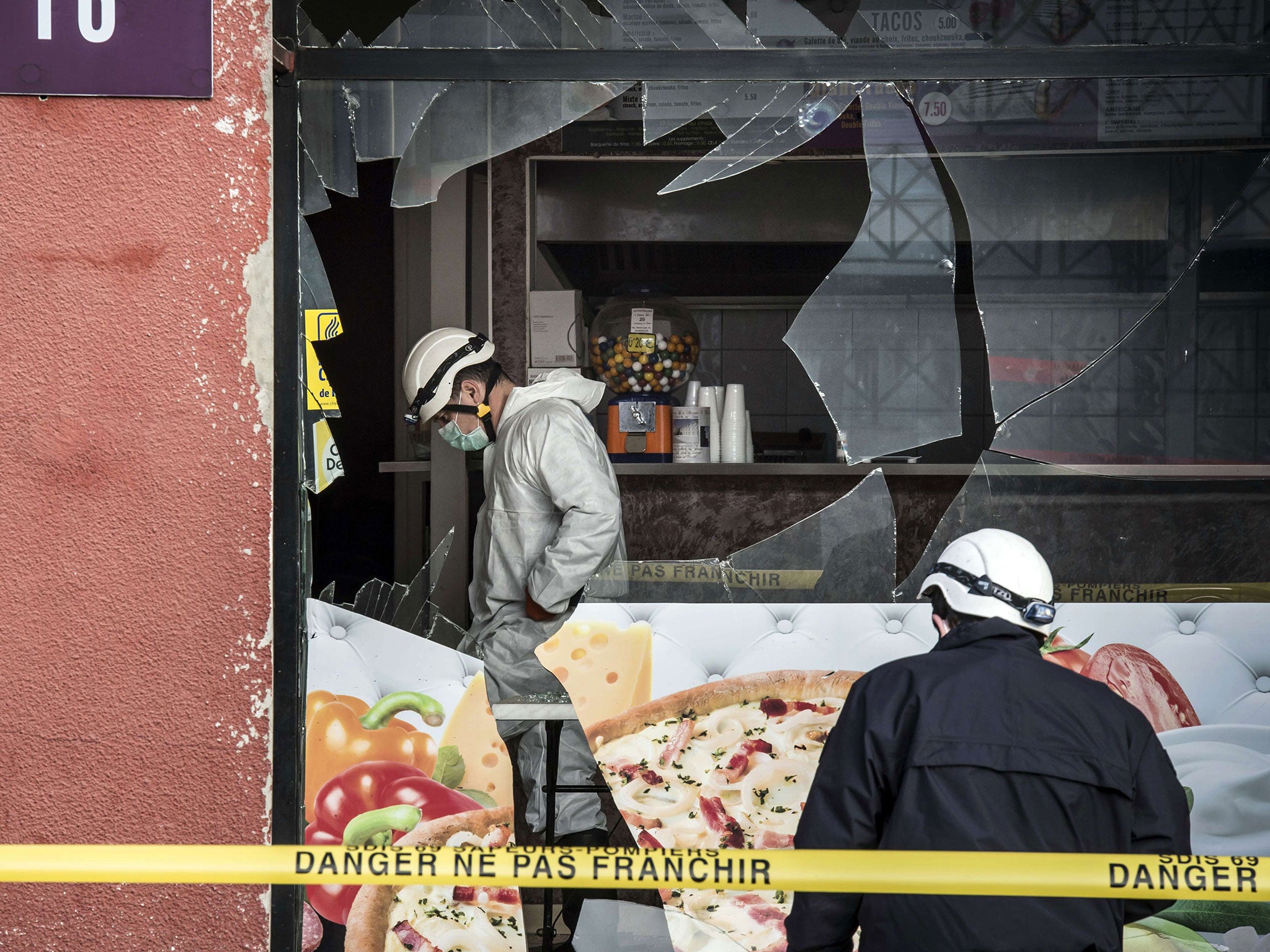 French police forensic scour the scene of an explosion at a kebab shop damaged following an explosion near a mosque, in Villefranche-sur-Saone, eastern France