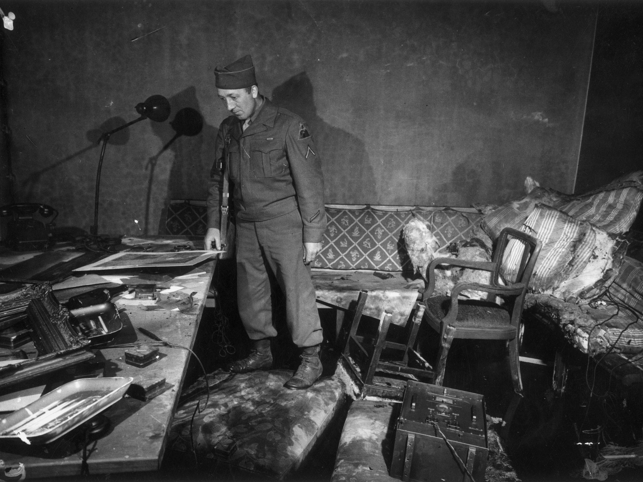 1945: Private First Class Richard Blust of Michigan surveys the bunker at the German Reichschancellery in Berlin where Adolf Hitler and his wife Eva Braun are thought to have committed suicide