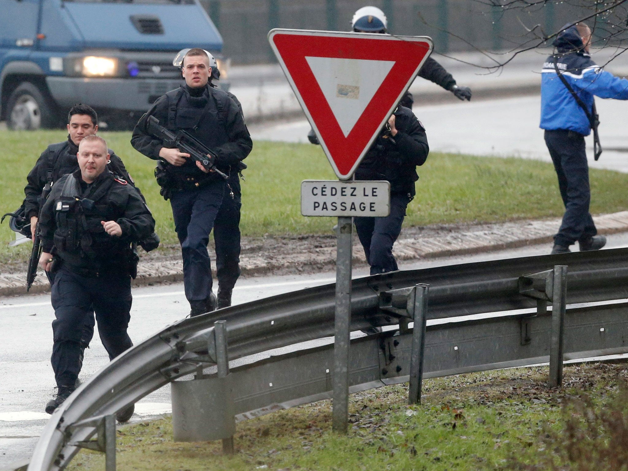 Members of the French intervention gendarme forces arrive at the scene of a hostage taking at an industrial zone in Dammartin-en-Goele, northeast of Paris