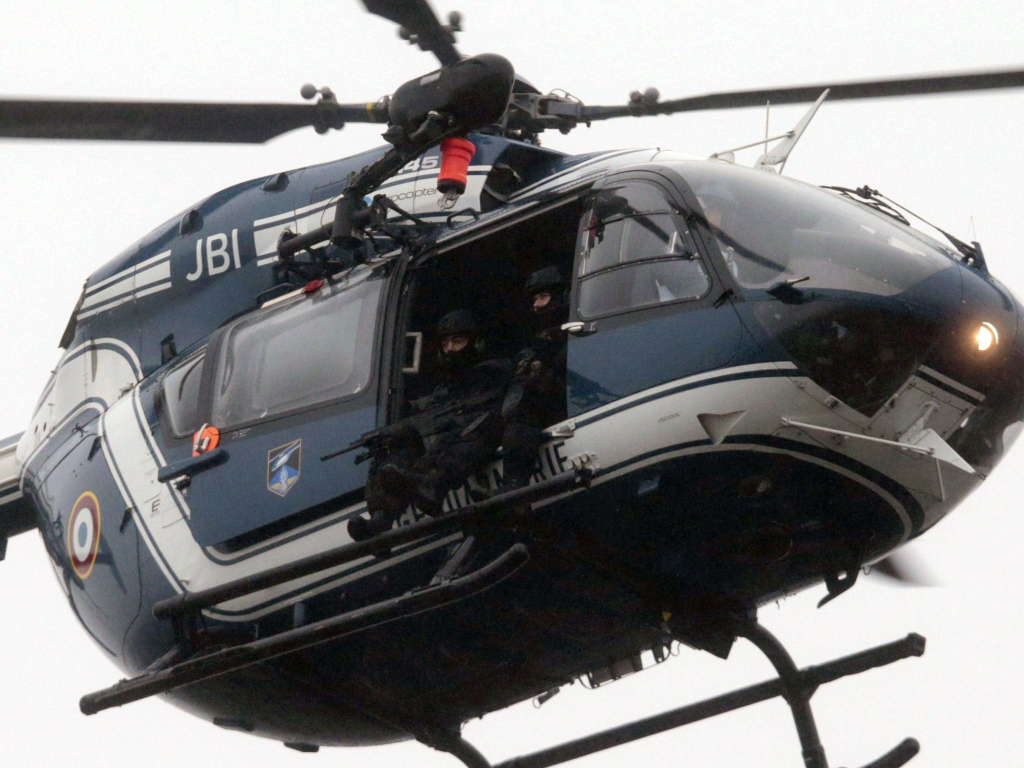 A helicopter of the French Gendarmerie flies over Dammartin-en-Goele