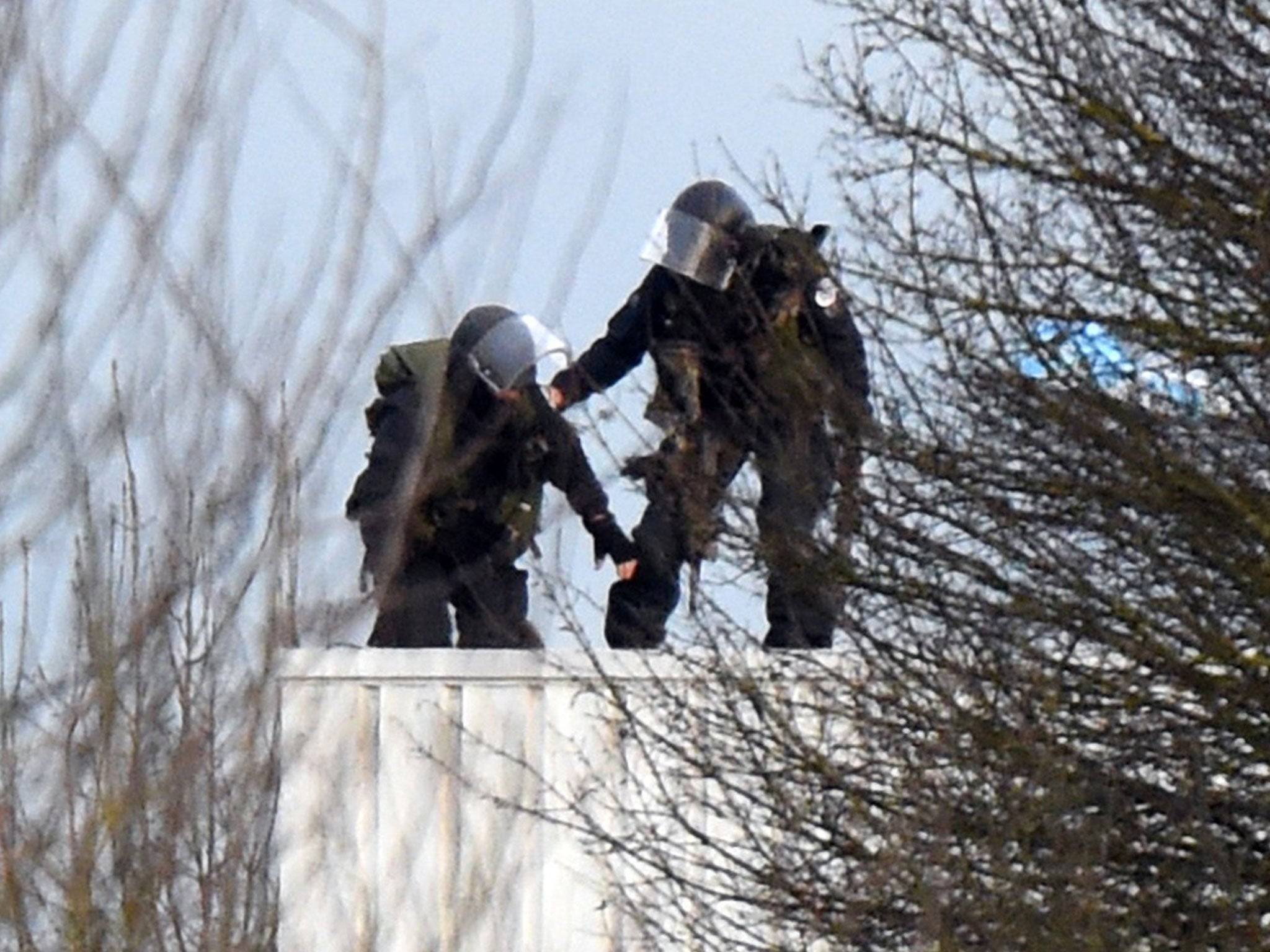 Police take up a position on a roof in Dammartin-en-Goele, north-east of Paris, where two brothers suspected of slaughtering 12 people in an Islamist attack on French satirical newspaper Charlie Hebdo held one person hostage as police cornered the gunmen