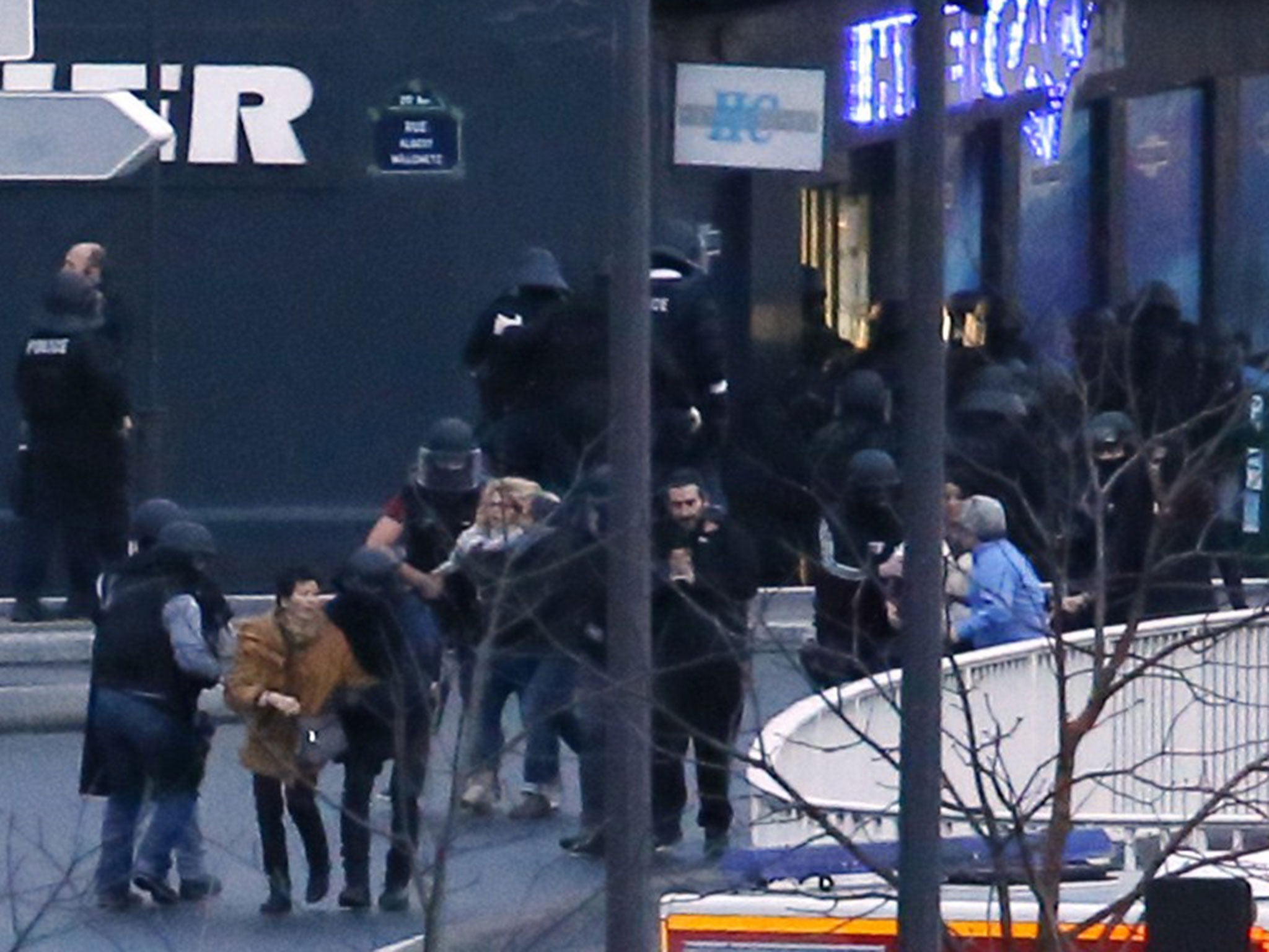 Members of the French police special forces evacuate the hostages after launching the assault at a kosher grocery store in Porte de Vincennes, eastern Paris