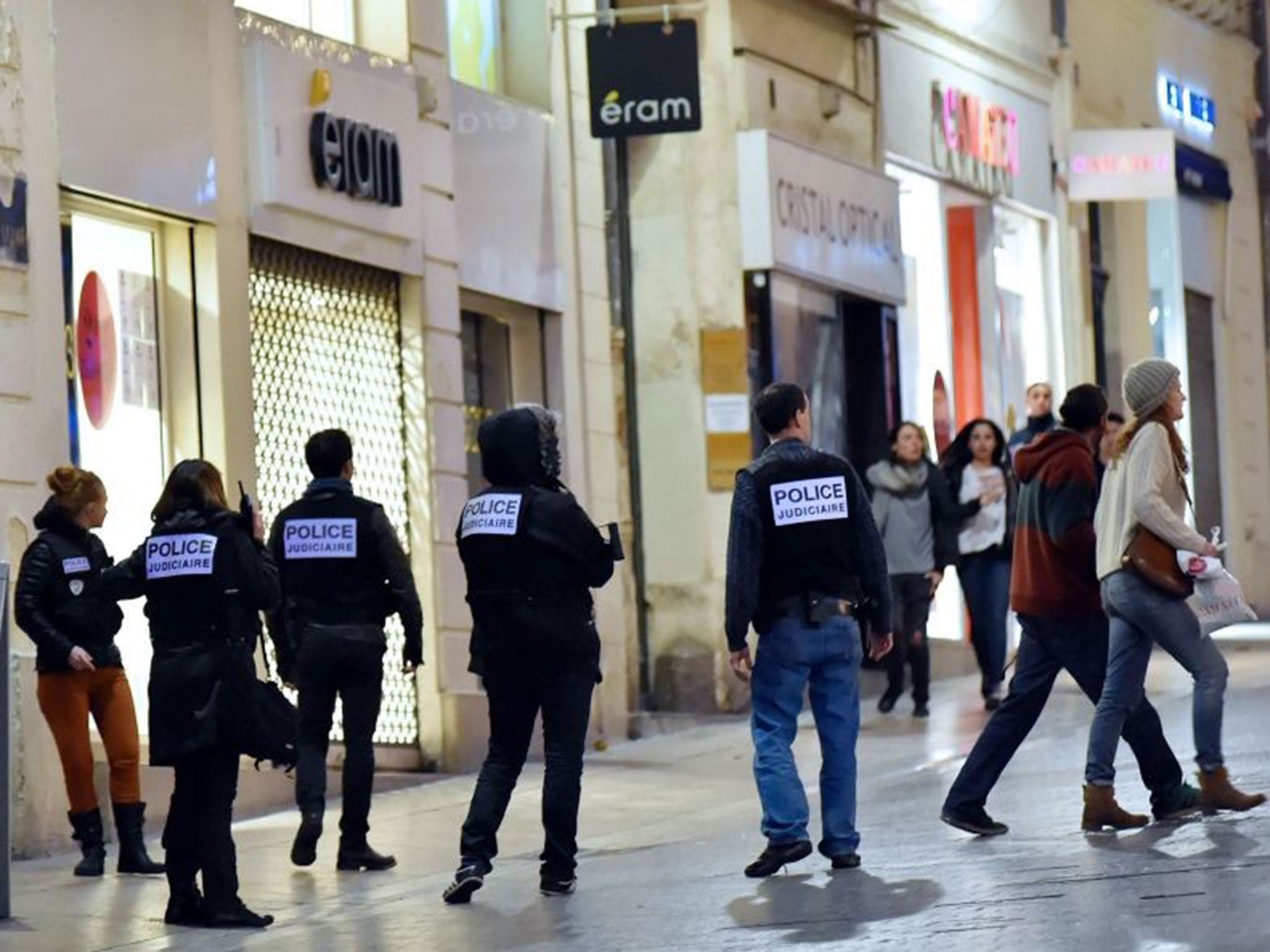 Police usher shoppers away from a jewellery shop in Montpellier where a gunmen was holding staff hostage