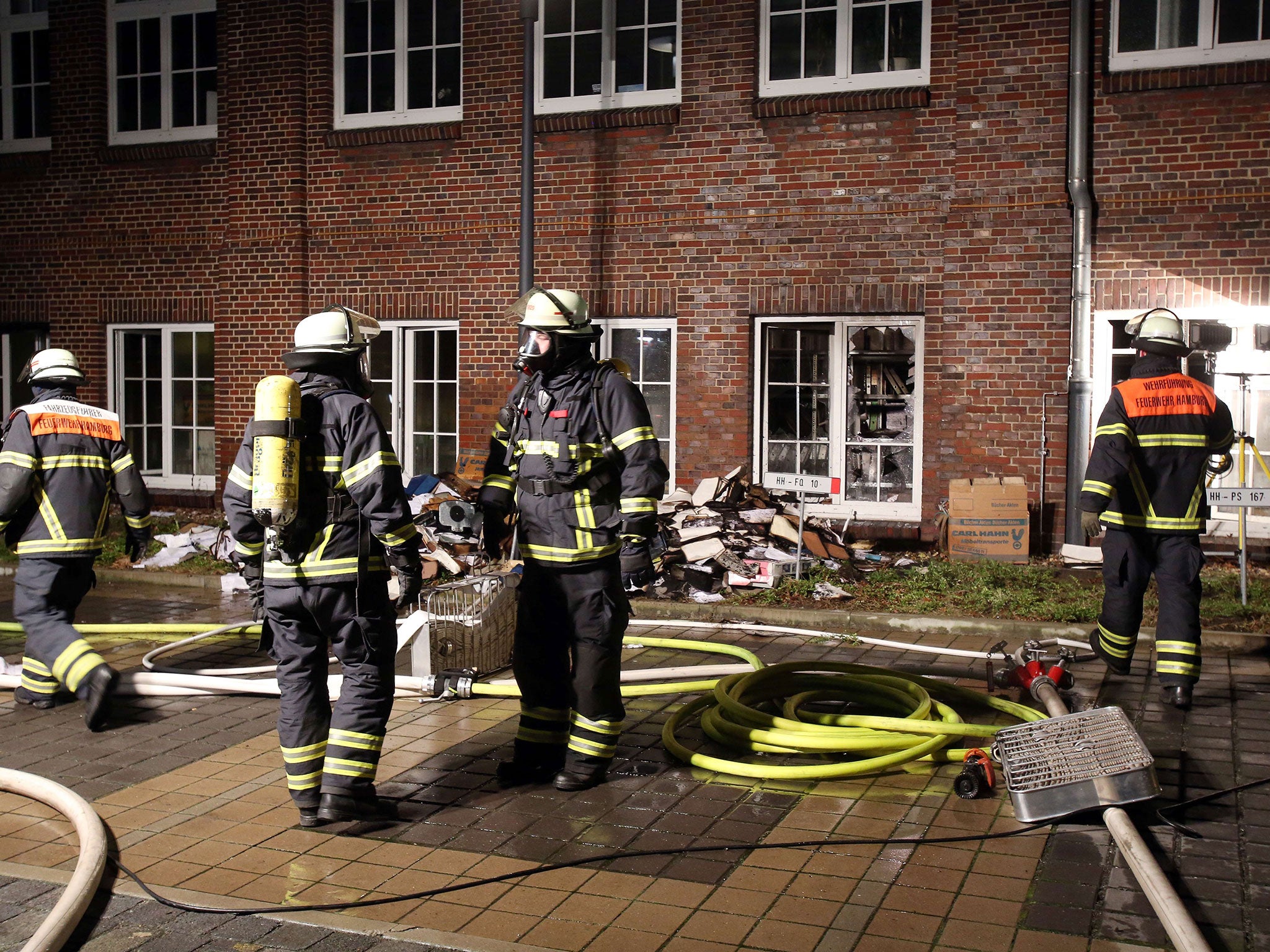 Firemen at the scene of an arson attack on the headquarters of German daily Hamburger Morgenpost