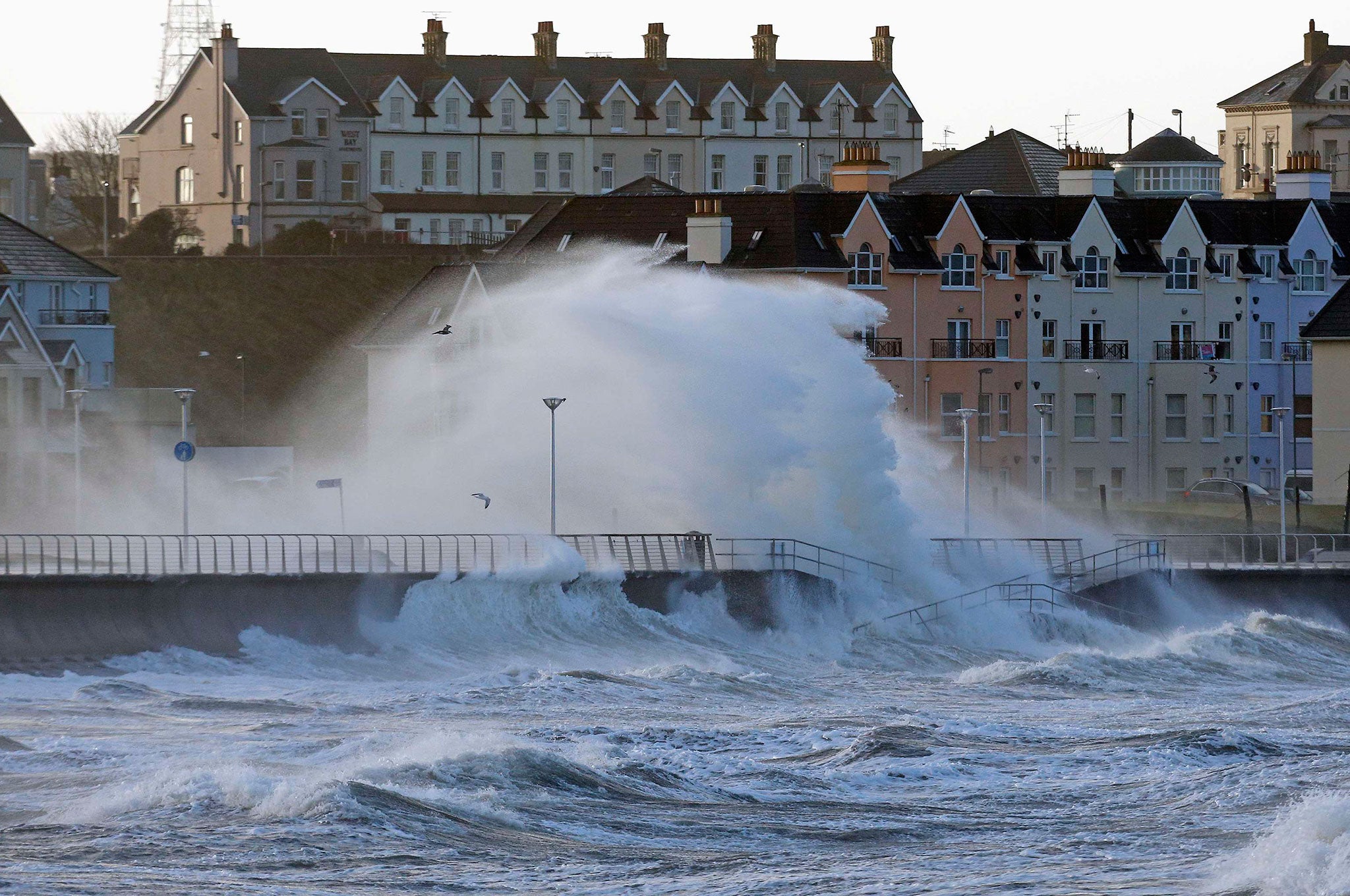 Waves crash against the sea wall in the town of Portrush, as storms hit the United Kingdom