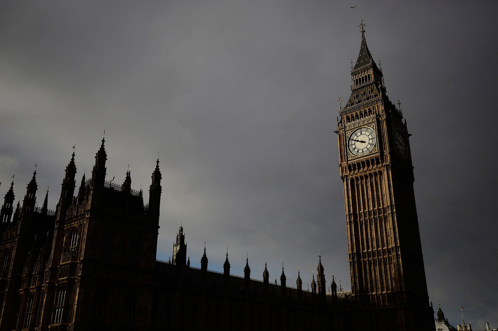 Dark clouds gather above the Elizabeth Tower and the Houses of Parliament before a rain storm in London