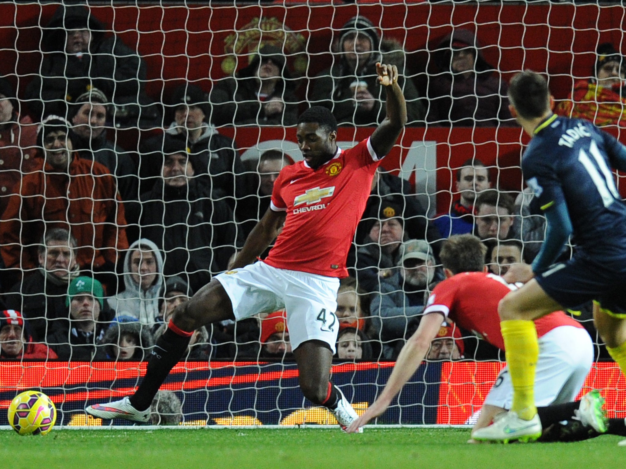 Manchester United defender Tyler Blackett can't reach the shot from Southampton's Serbian midfielder Dusan Tadic