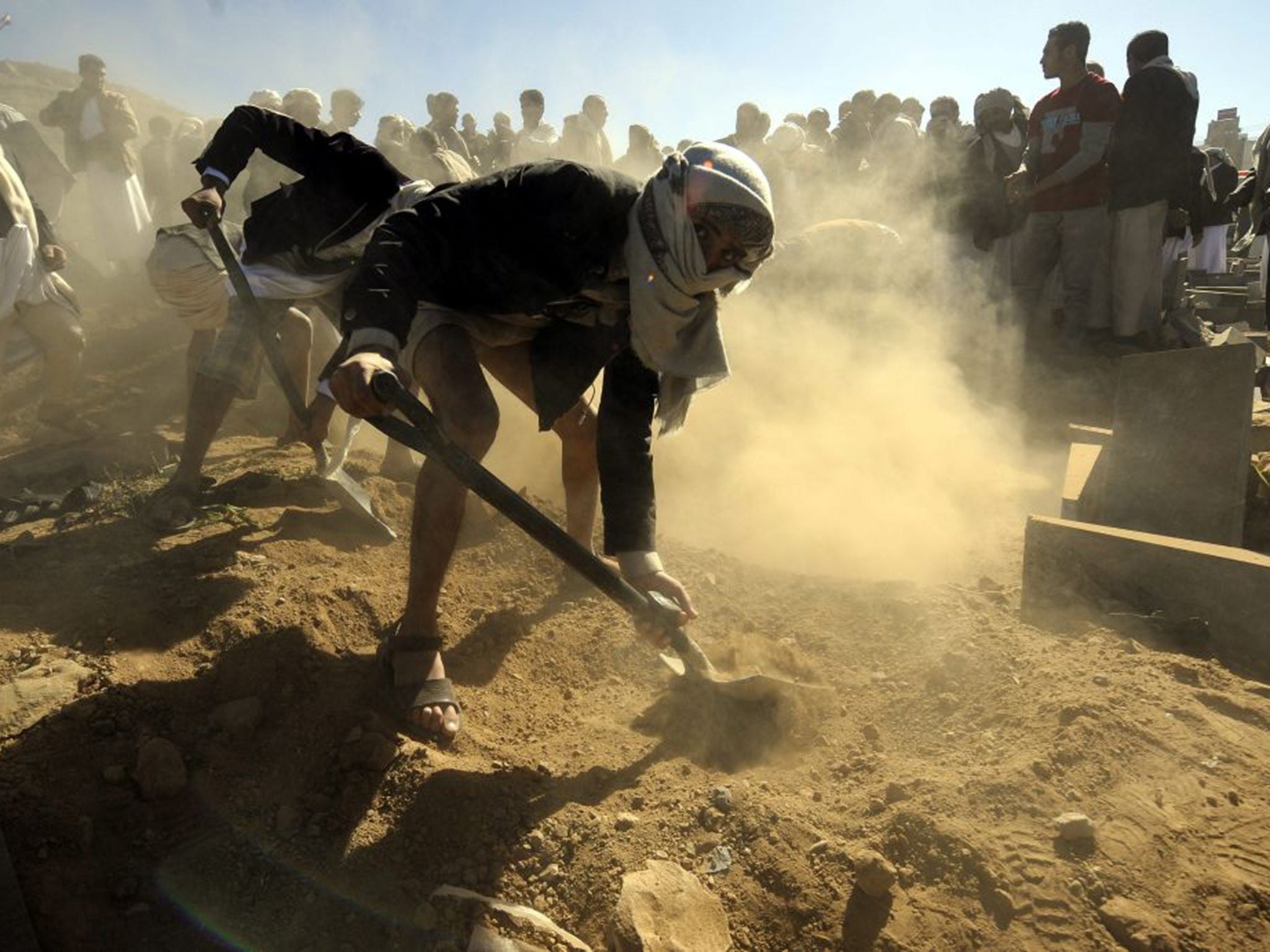 Mourners bury victims who died last week after a car bomb exploded outside a police academy in Sanaa, Yemen. At least 40 people were killed in the attack, and 71 injured (EPA)