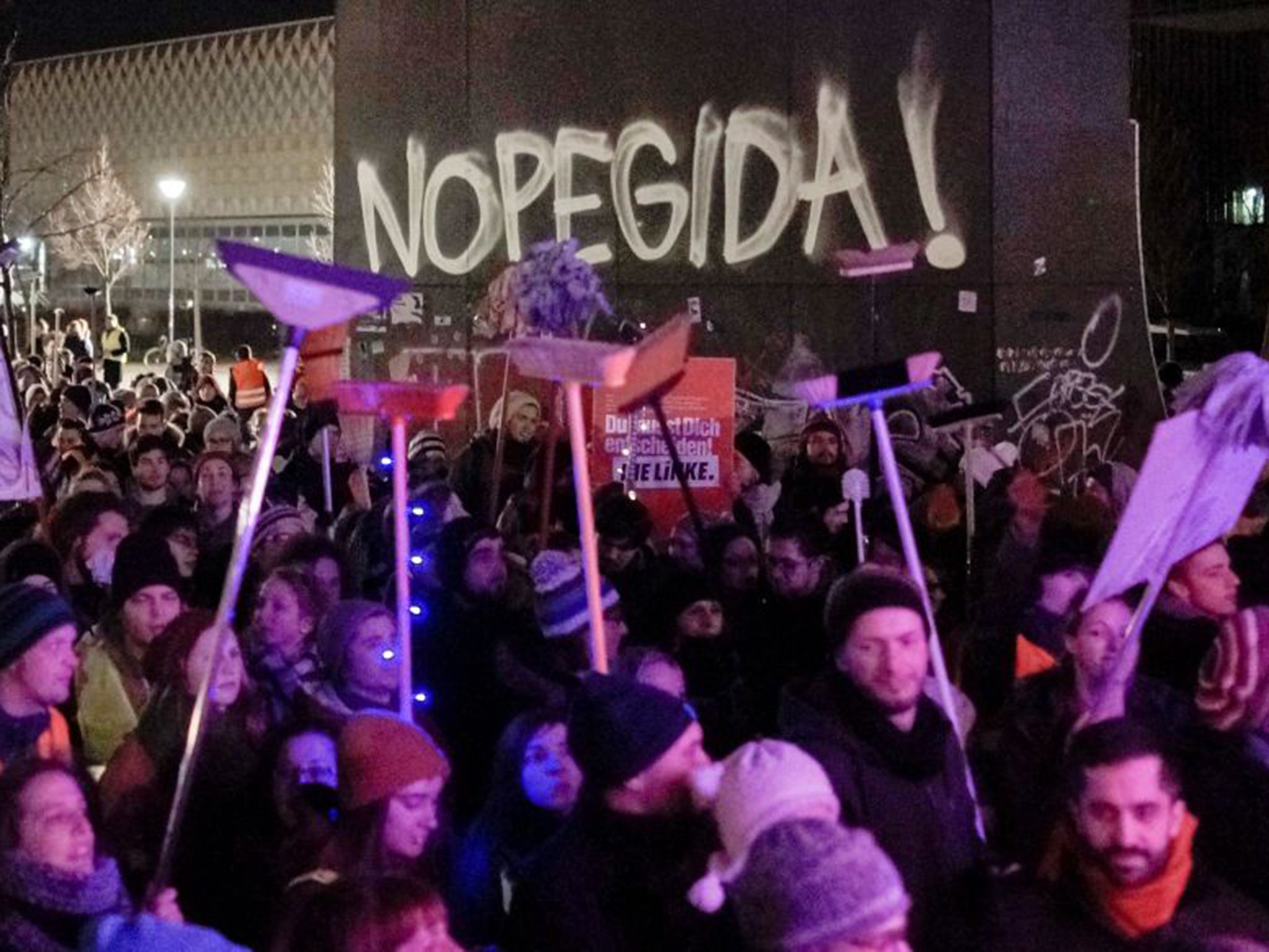 Counter-protesters held brooms in a symbolic gesture to "sweep" away racism and intolerance