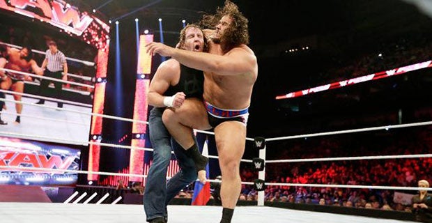 Rusev knees Dean Amrose in the mid-section