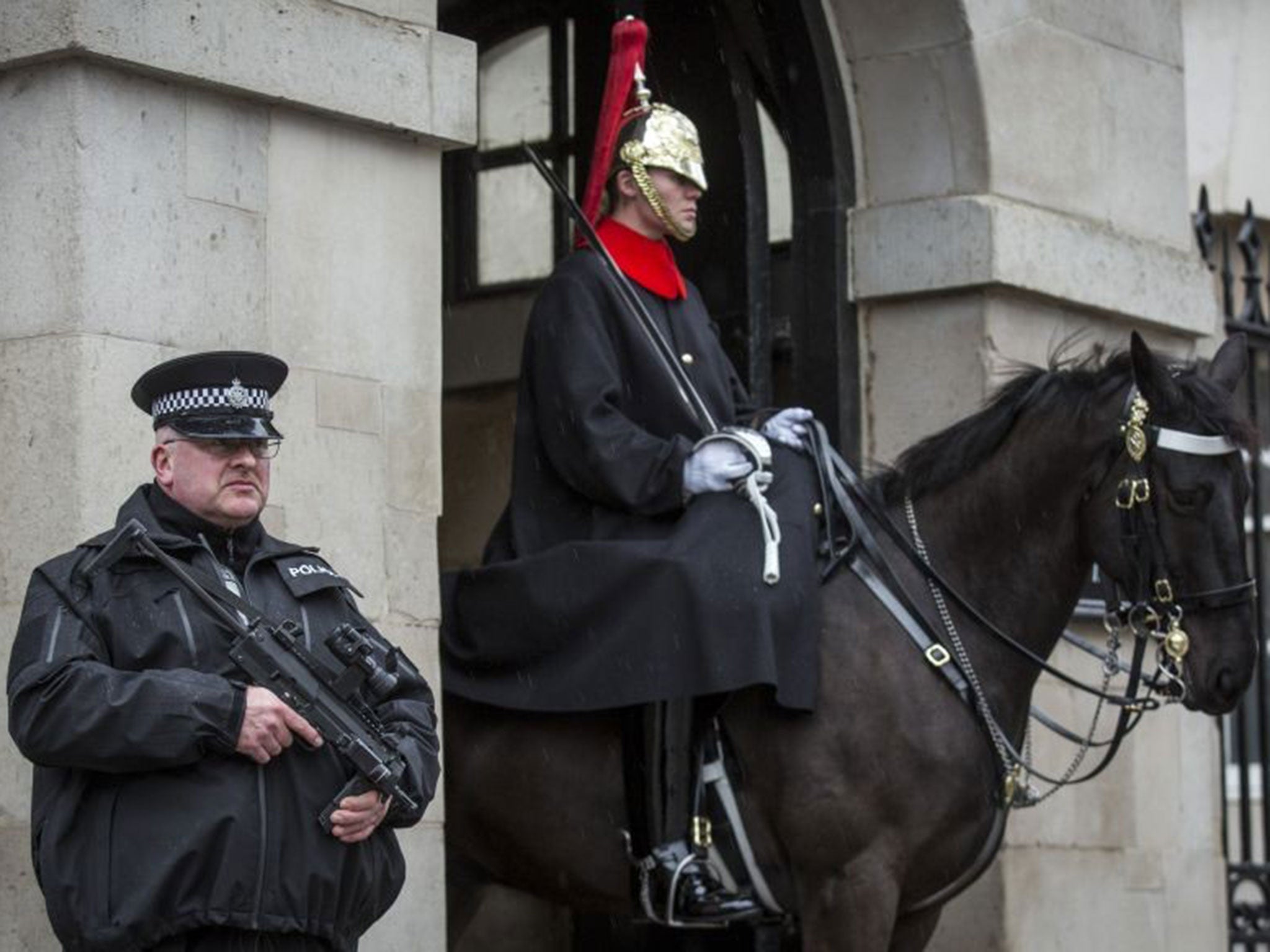 An armed police officer patrols on Whitehall on January 12, 2015 in London