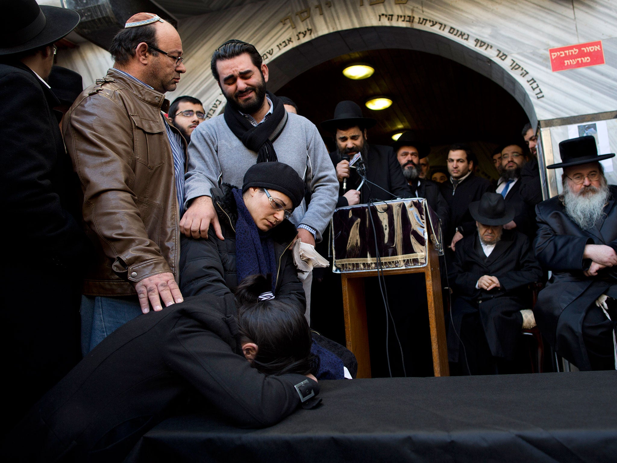 Family and relatives of French Jew Yoav Hattab, a victim of the attack on kosher grocery store in Paris, gather around a symbolic coffin for his funeral procession in the city of Bnei Brak near Tel Aviv, Israel