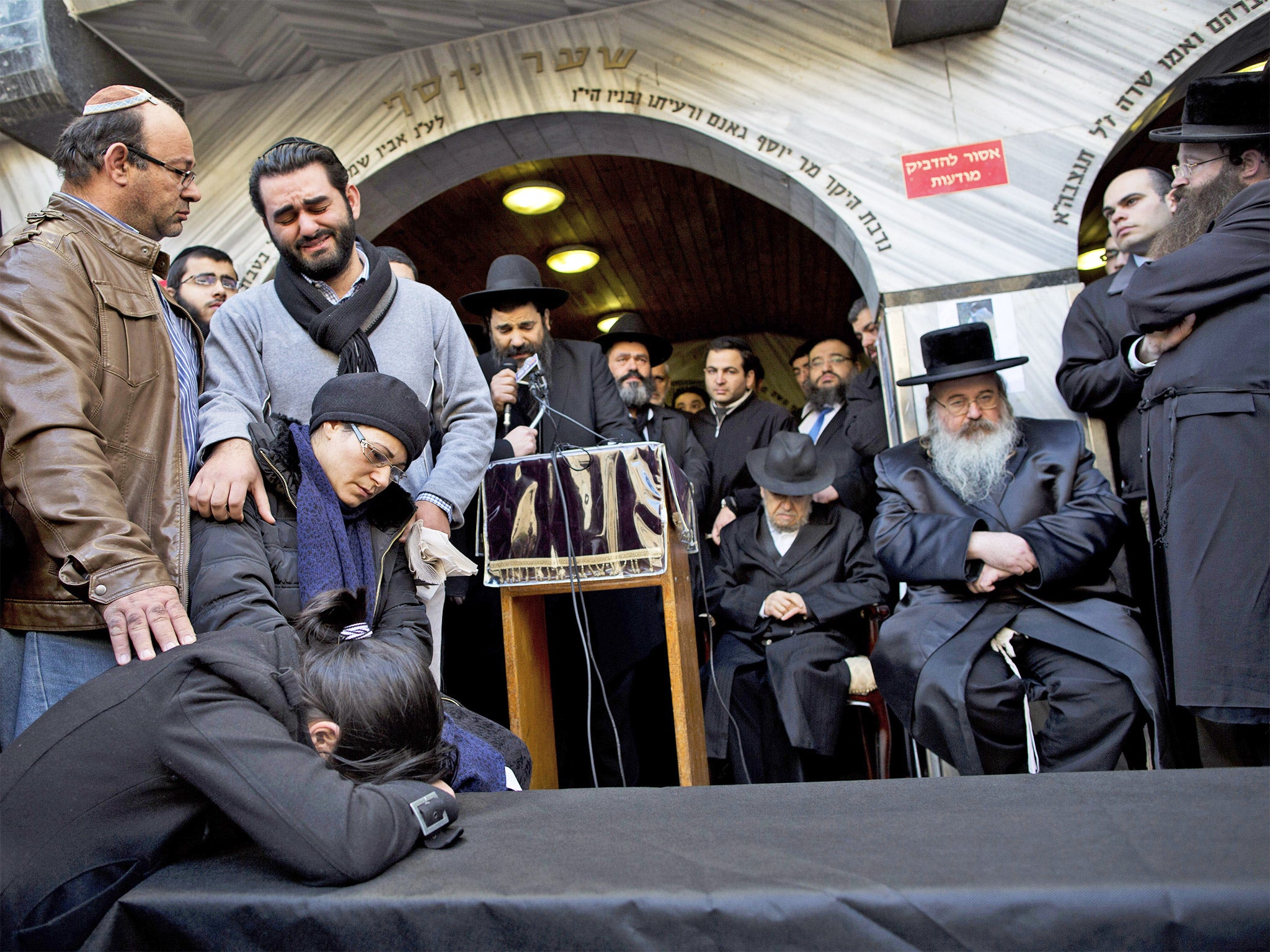 Family and relatives of French Jew Yoav Hattab, a victim of the attack on the kosher grocery store in Paris, gather around a symbolic coffin for his funeral procession in the city of Bnei Brak near Tel Aviv