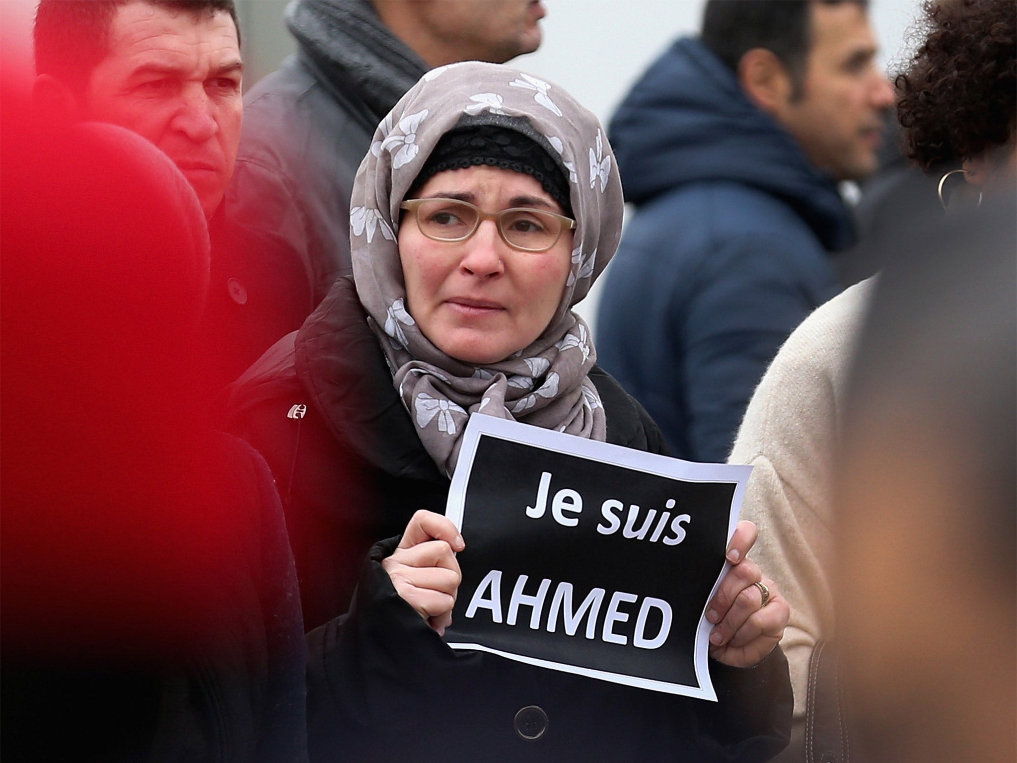 A mourner holds a sign saying 'Je suis Ahmed' (I am Ahmed) during the funeral of murdered police officer Ahmed Merabet, in Bobigny, France