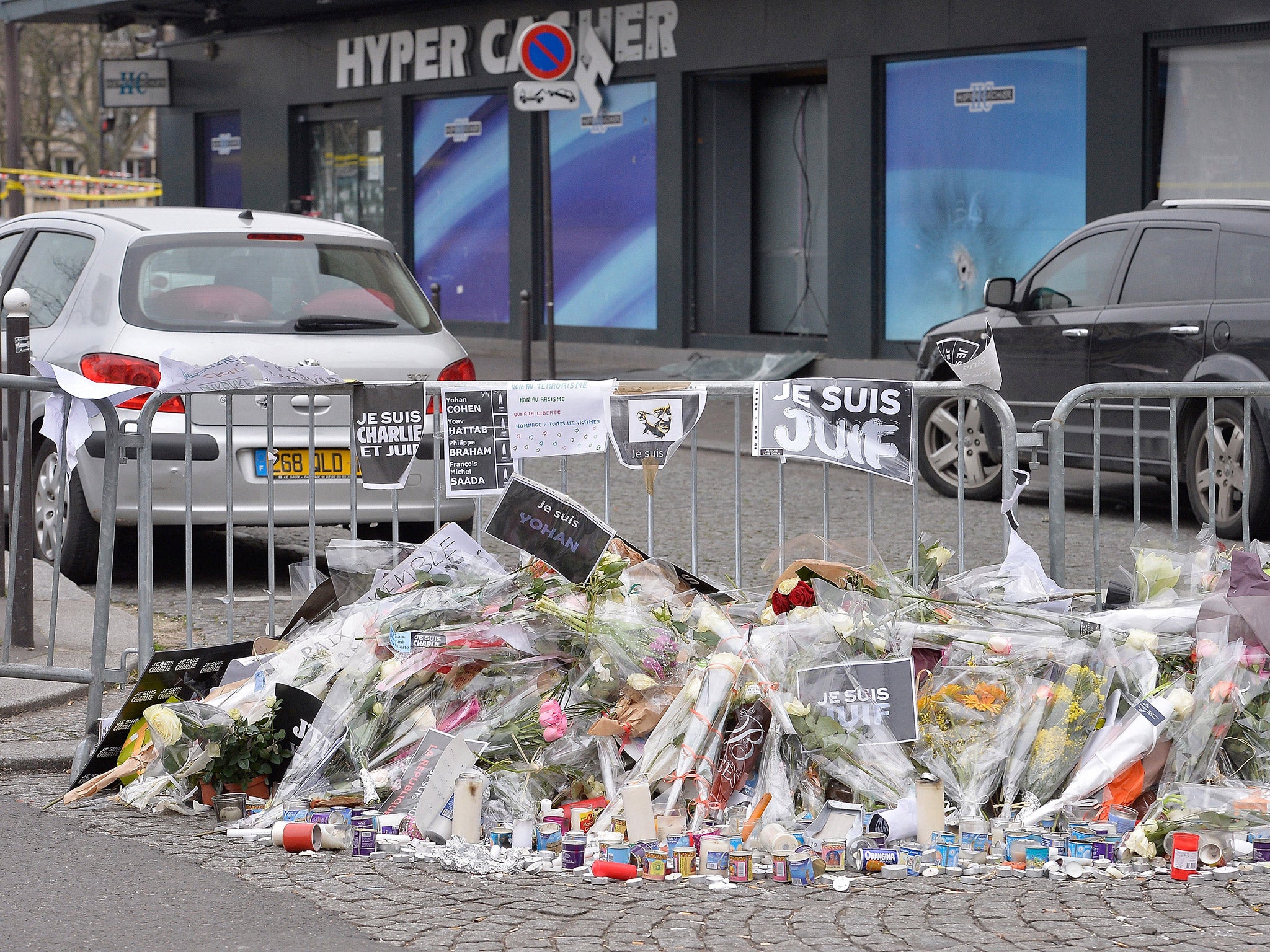 Flowers are laid outside the kosher supermarket in Paris where four French Jews lost their lives last week (Getty)