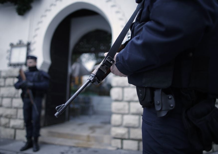 French police stand guard in front of the entrance of the Paris Grand Mosque