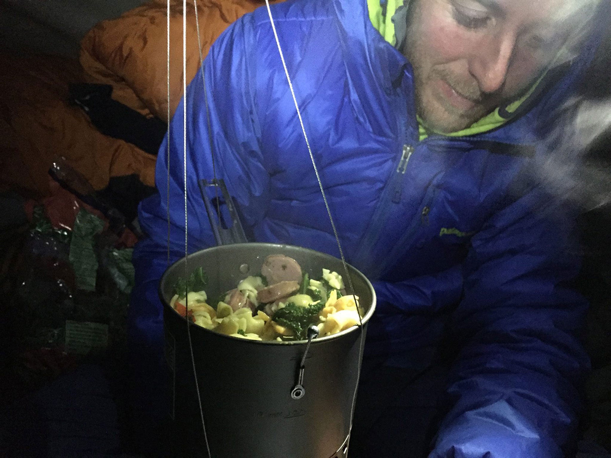 Tommy Caldwell prepares a meal during his climb