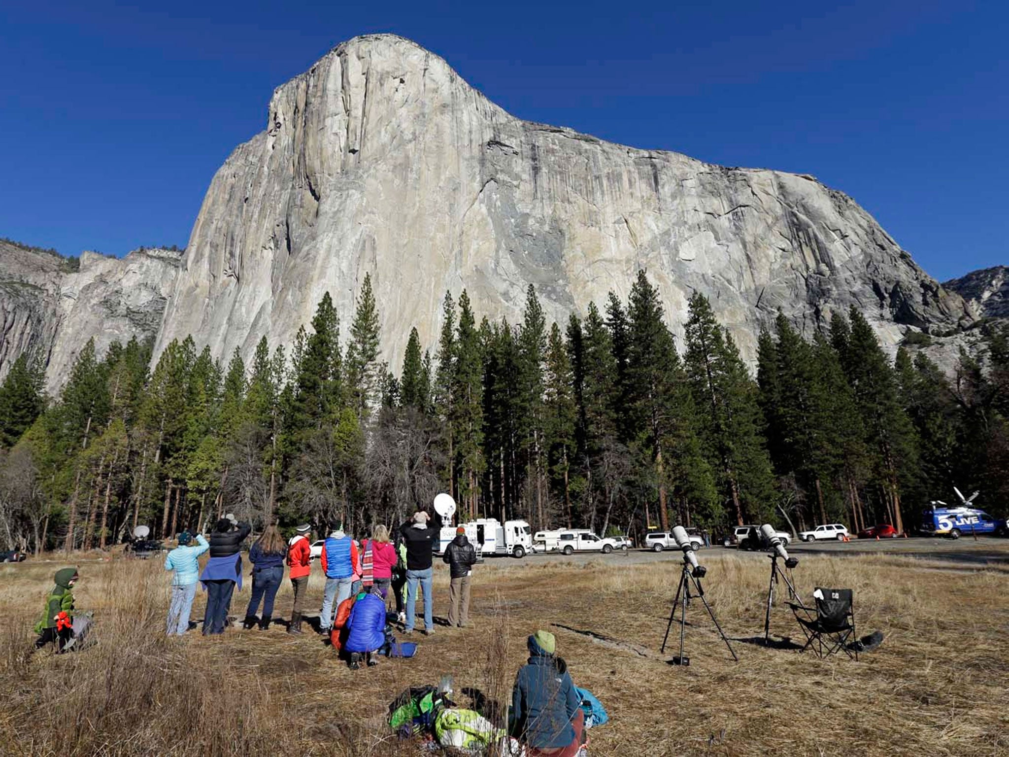 Spectators gaze at El Capitan for a glimpse of climbers Tommy Caldwell and Kevin Jorgeson, as seen from the valley floor in Yosemite National Park