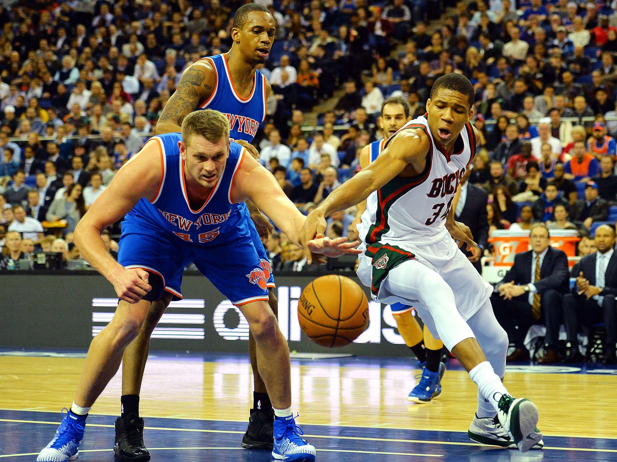 Milwaukee Bucks' Giannis Antetokounmpo (right) challenges New York Knicks' Cole Aldrich (left) during the 2015 NBA global game between Milwaukee Bucks and New York Knicks