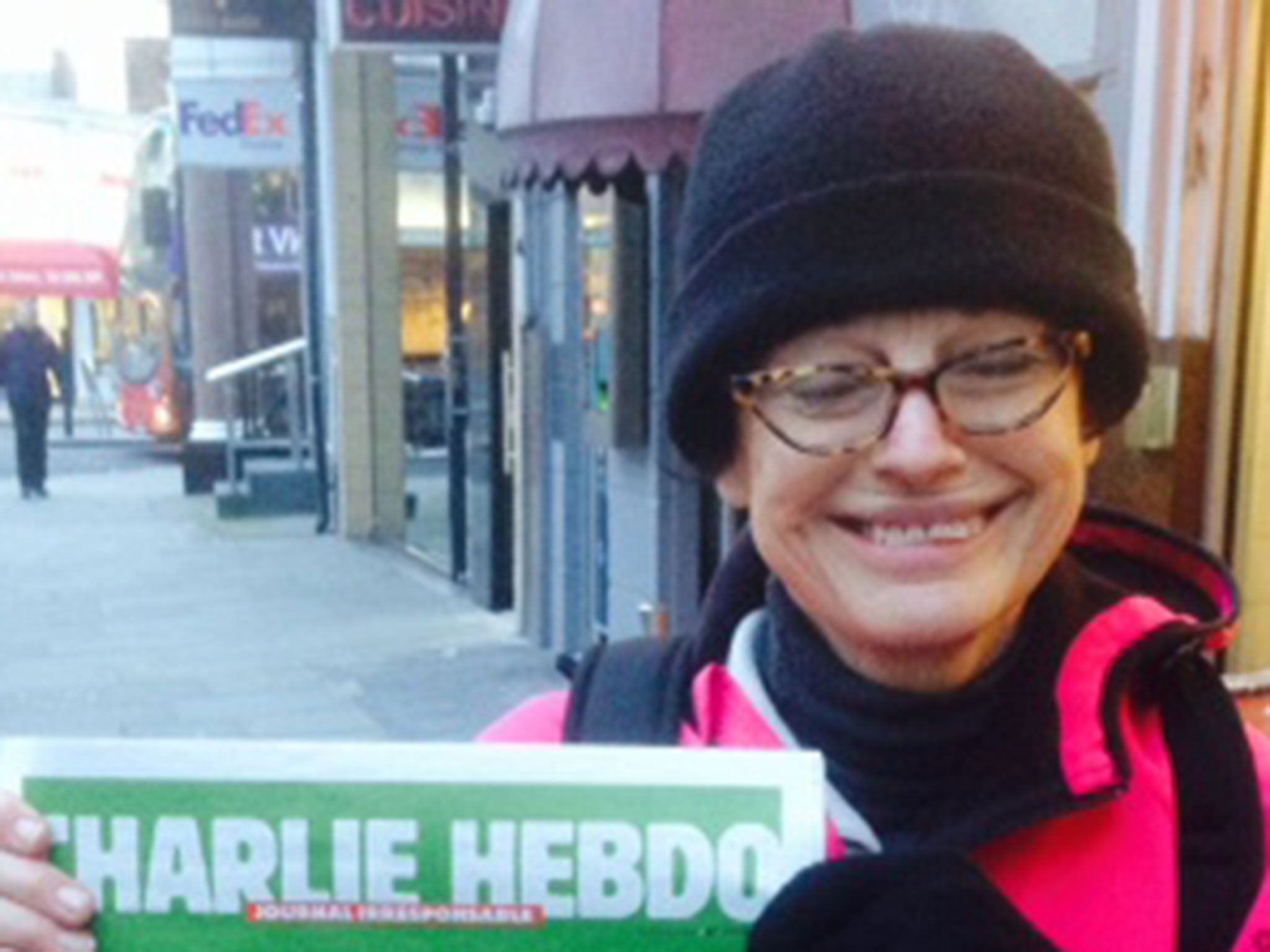 A customer who queued in the early hours of Friday to buy the latest edition of Charlie Hebdo.