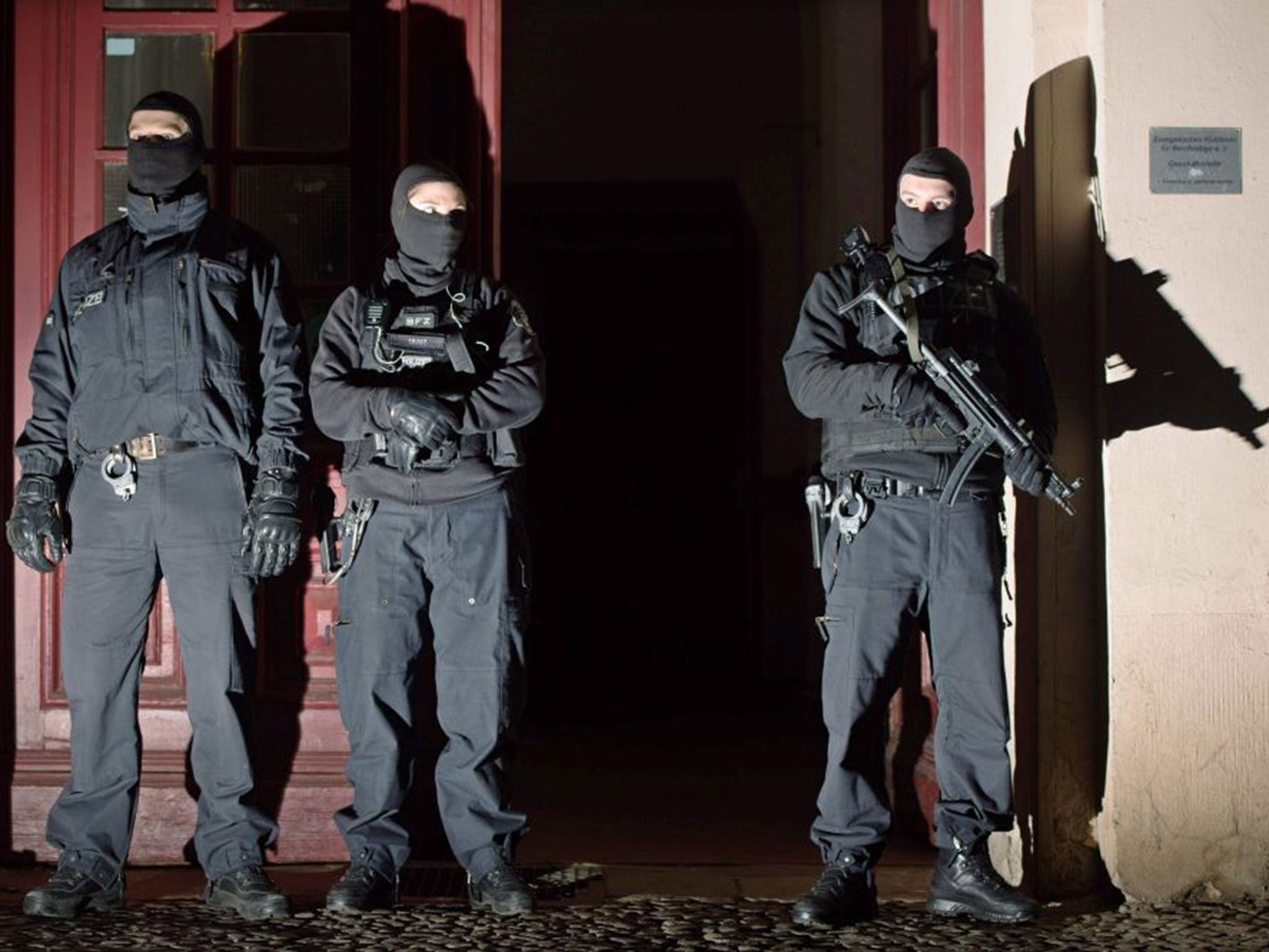 Members of a special German anti-terror police outside an apartment block in Perleberger Strasse, Berlin, after two men were arrested on 16 January 2015.