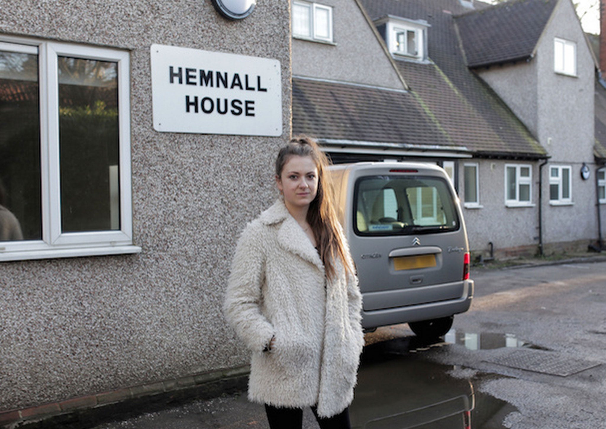 The author pictured outside her temporary accommodation after being evicted from her home in 2013