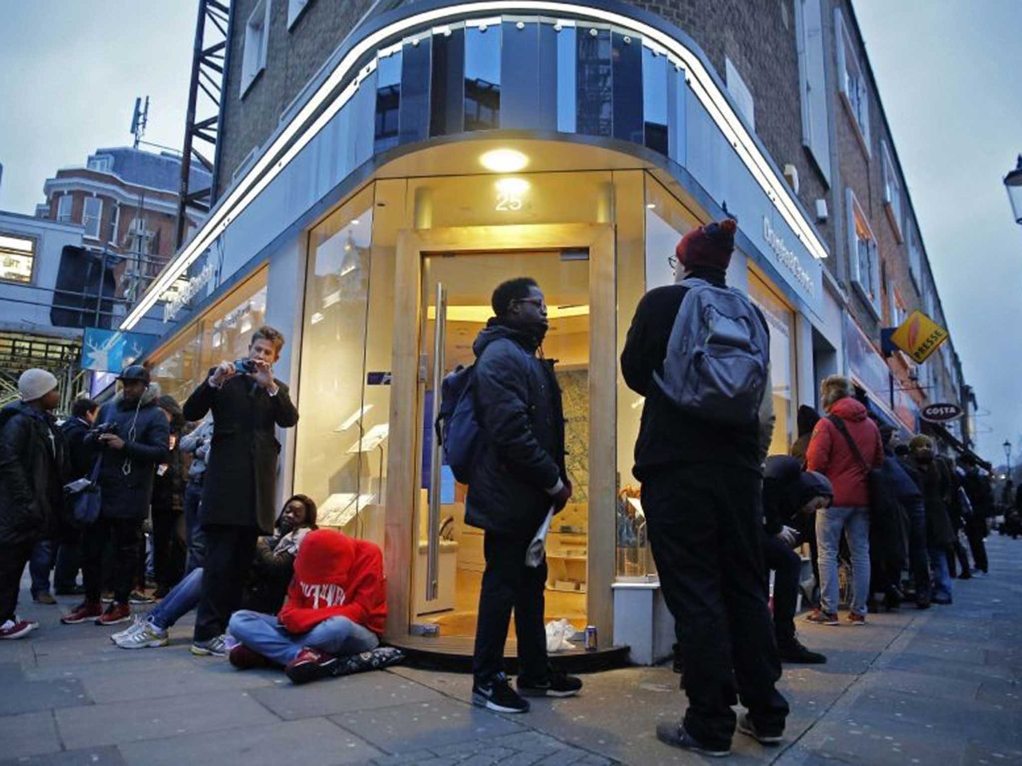 People queue around the corner to get hold of an issue of Charlie Hebdo this morning