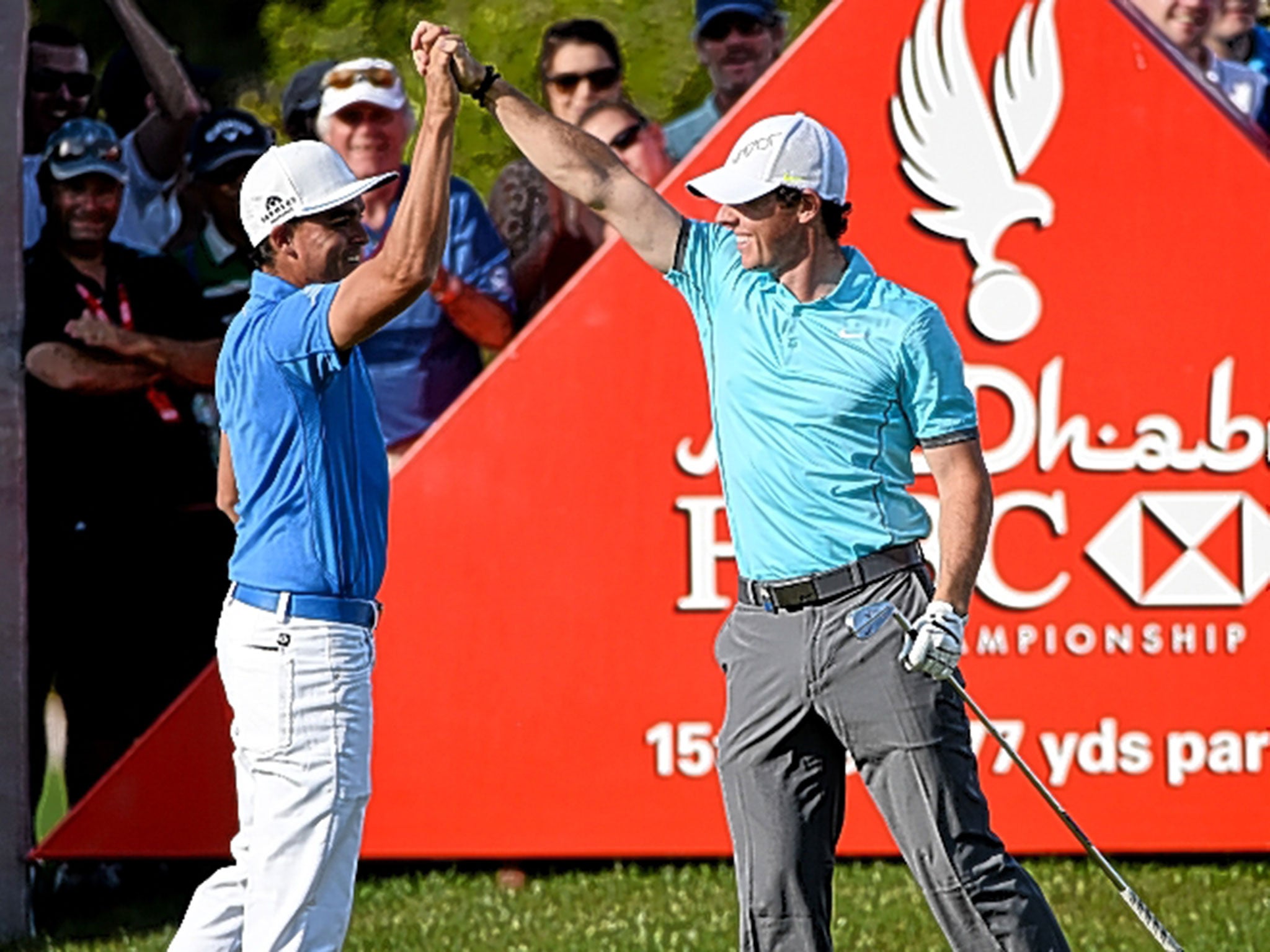 McIlroy (right) high fives with Rickie Fowler after his hole-in-one