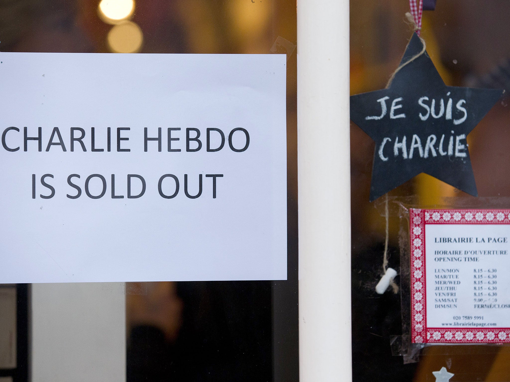 A sign that reads 'Charlie Hebdo Is Sold Out' is seen in the window of a French book shop, earlier selling the satirical magazine Charlie Hebdo, in London