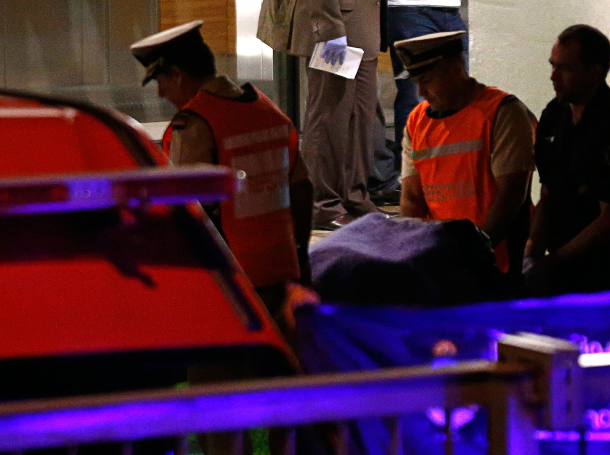 Emergency teams remove body of Alberto Nisman from his apartment block.