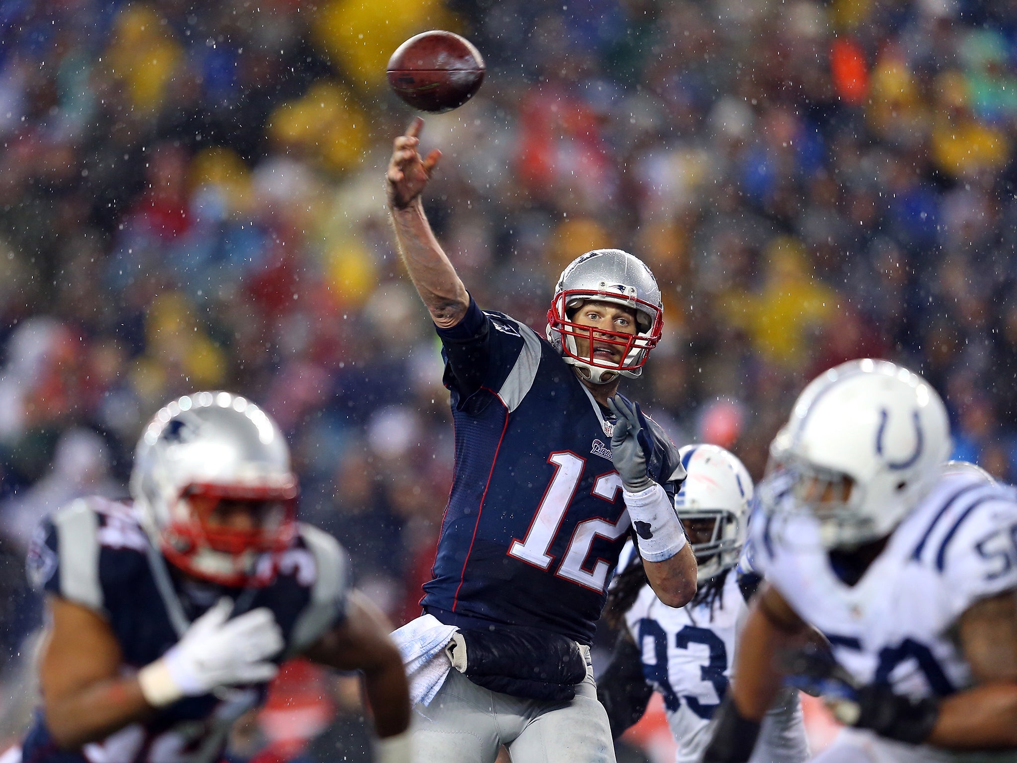 Tom Brady #12 of the New England Patriots throws a touchdown pass to Rob Gronkowski #87 (not pictured) in the third quarter against the Indianapolis Colts