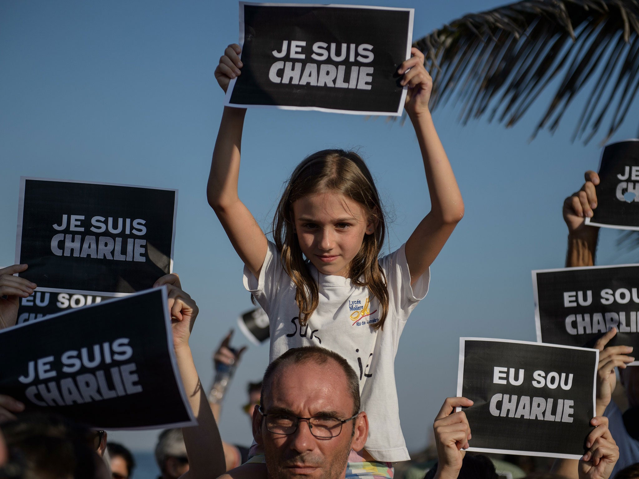 People march during a rally in Rio de Janeiro, Brazil in tribute to the 17 victims of the attacks in France