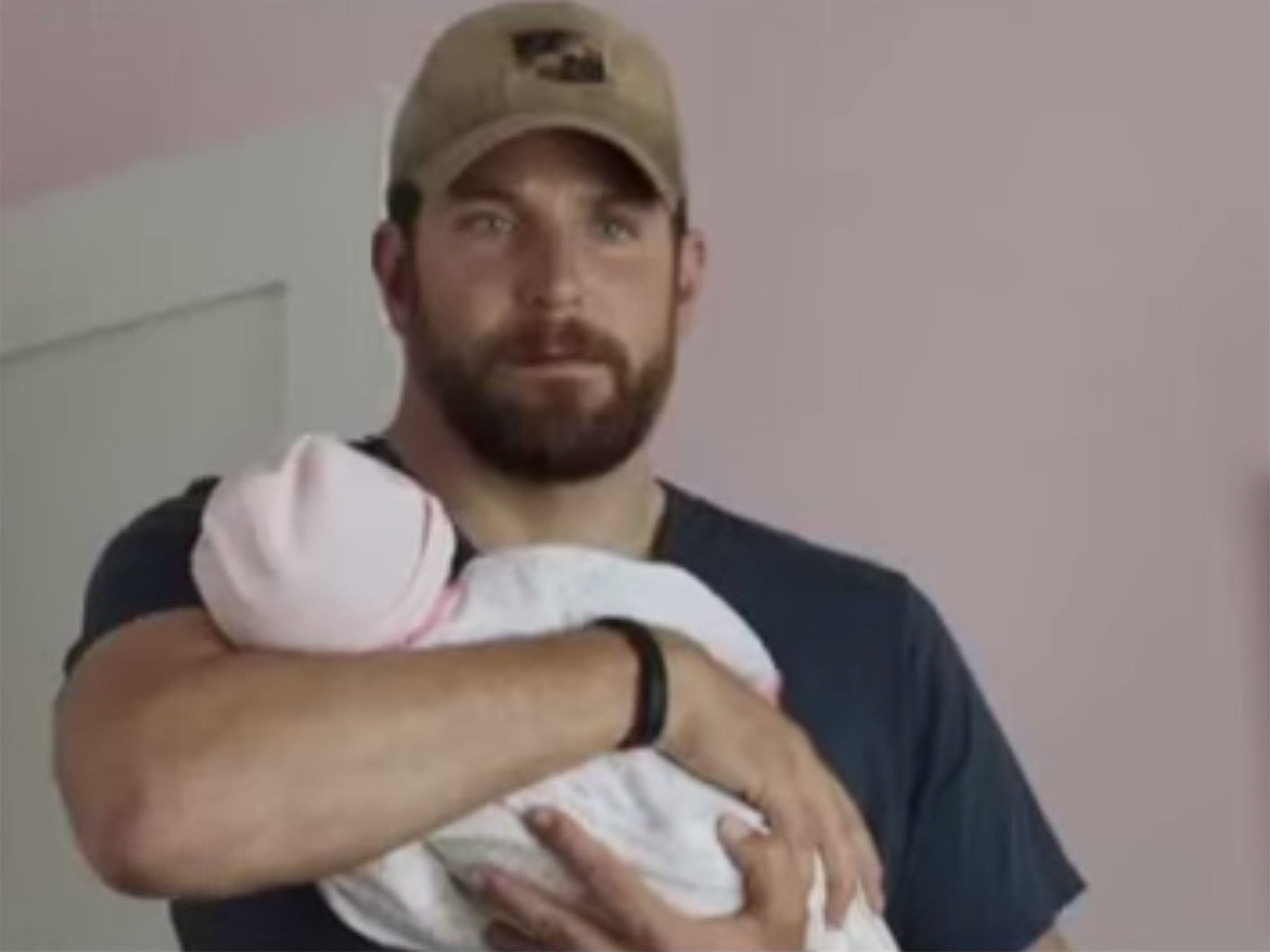 Bradley Cooper holds his fake baby in American Sniper